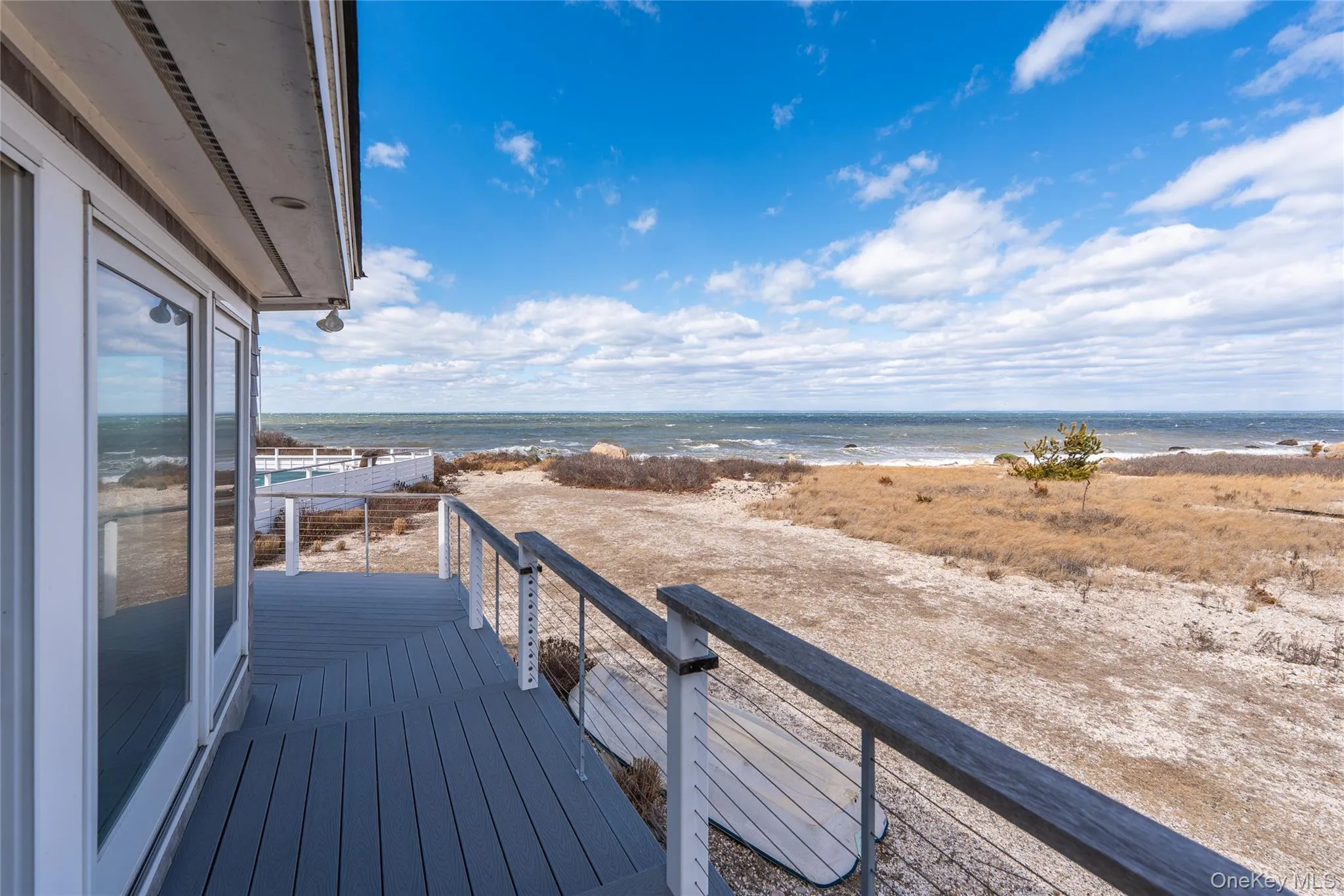 Balcony with a view of the beach and a water view Balcony with a view of the beach and a water view