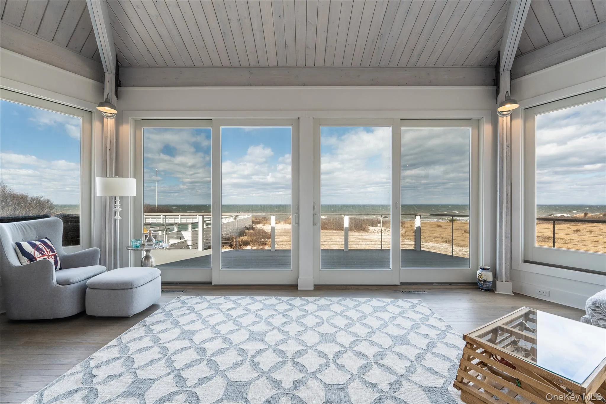 Sunroom featuring vaulted ceiling, wooden ceiling, and hardwood / wood-style flooring Sunroom featuring vaulted ceiling, wooden ceiling, and hardwood / wood-style flooring