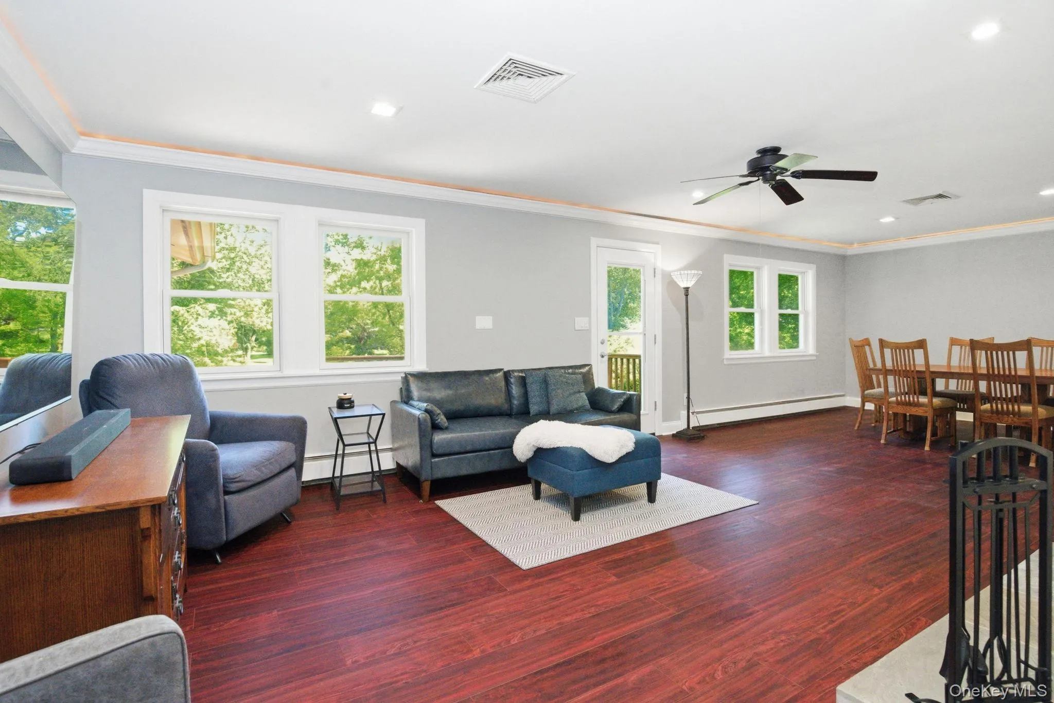 Sun-filled living and dining spaces flow together beneath custom lighted crown molding. Sun-filled living and dining spaces flow together beneath custom lighted crown molding.