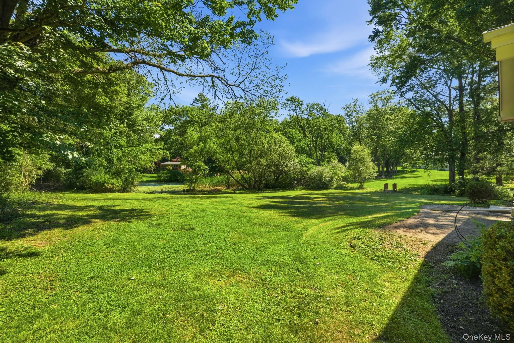Beyond the lawn, the grounds roll back into a natural, wooded edge where a private pond sits quietly at the rear of the property, drawing in birds and wildlife all season long. Beyond the lawn, the grounds roll back into a natural, wooded edge where a private pond sits quietly at the rear of the property, drawing in birds and wildlife all season long.