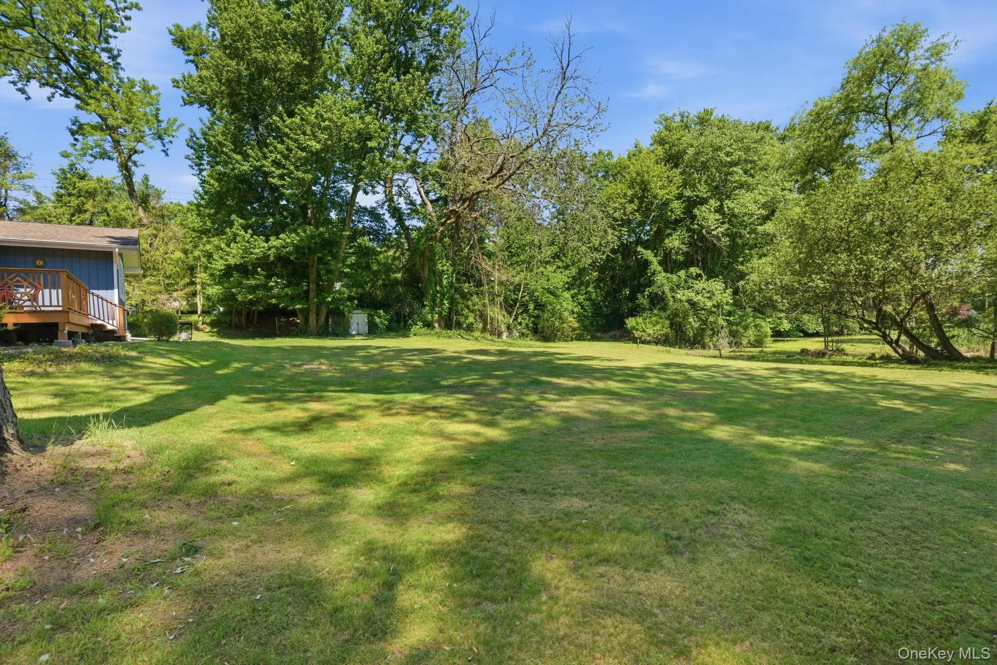 Level, open lawn runs from the side of the home to a mature wooded border, the kind of usable yard that feels increasingly rare this close to town. Level, open lawn runs from the side of the home to a mature wooded border, the kind of usable yard that feels increasingly rare this close to town.