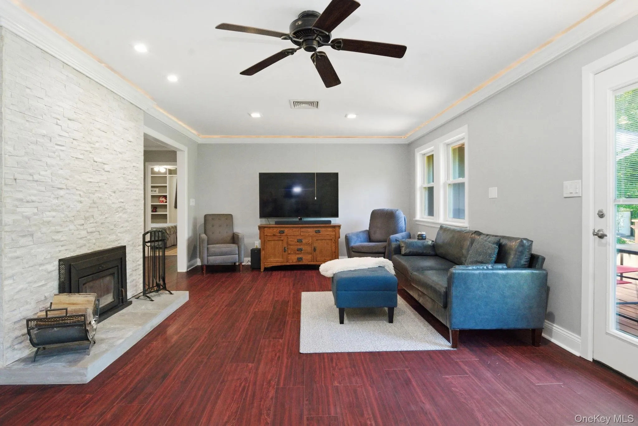 The living room centers on a striking stacked stone fireplace, the kind of focal point that anchors the whole home. The living room centers on a striking stacked stone fireplace, the kind of focal point that anchors the whole home.