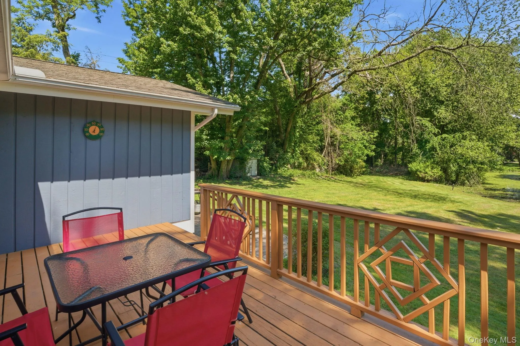 The deck looks out over a private, level backyard that rolls toward the trees, with the pond just beyond. The deck looks out over a private, level backyard that rolls toward the trees, with the pond just beyond.