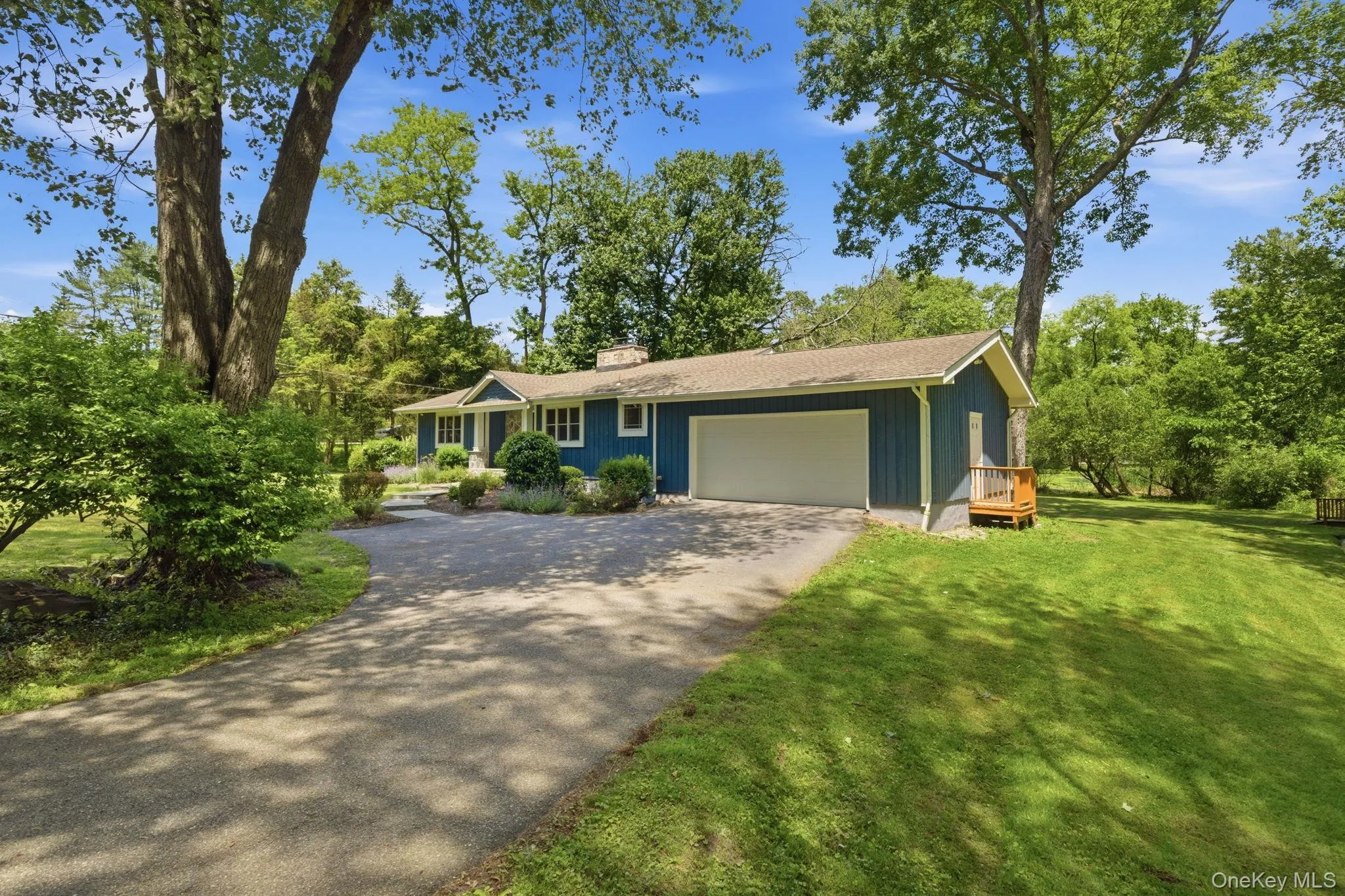 A long private driveway and attached two-car garage offers ample parking spaces. A long private driveway and attached two-car garage offers ample parking spaces.