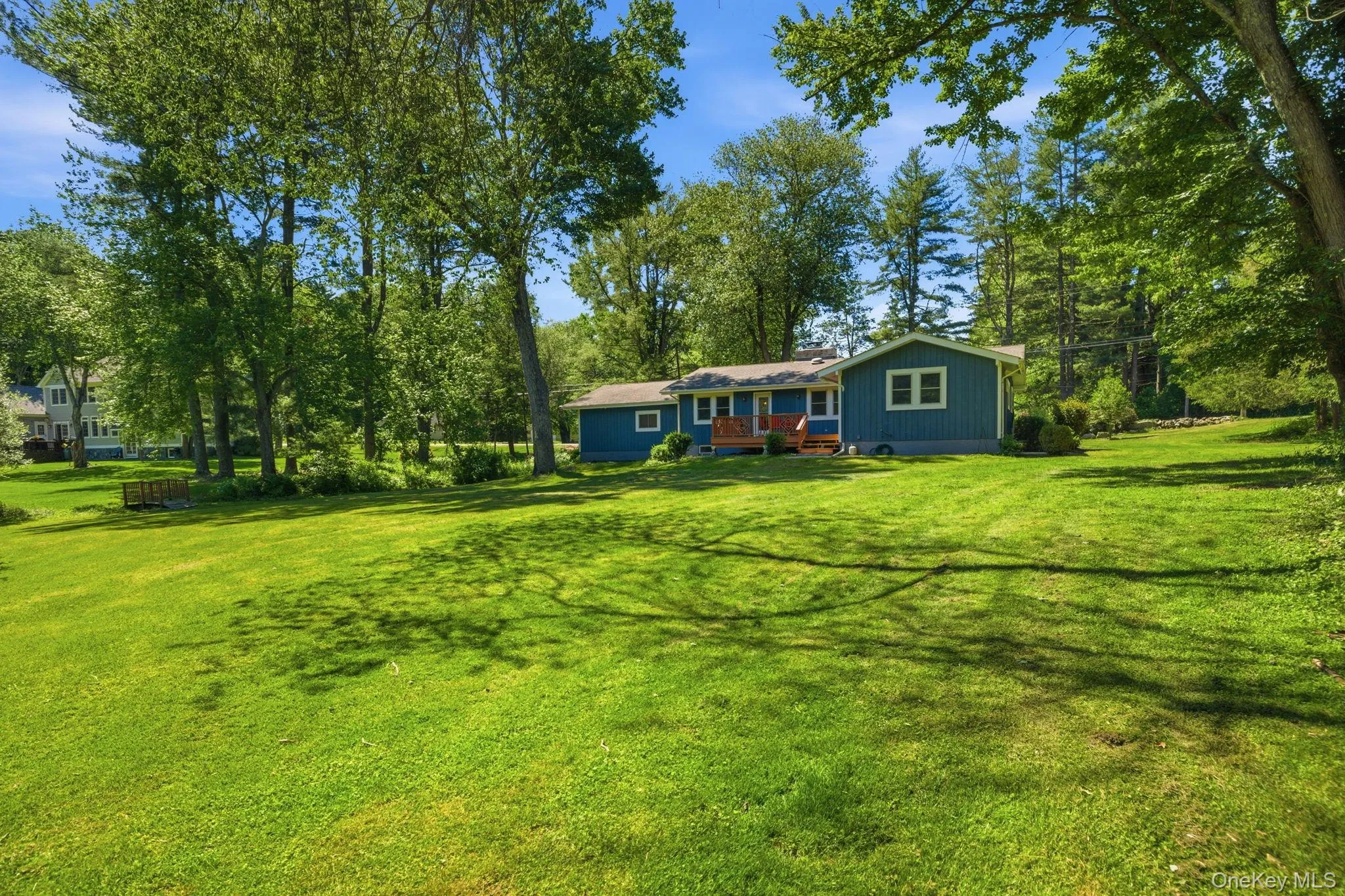 Set well back on a private 1.2-acre corner and framed by mature trees, the home looks out over an expanse of level, open lawn with room to grow into for years to come. Set well back on a private 1.2-acre corner and framed by mature trees, the home looks out over an expanse of level, open lawn with room to grow into for years to come.