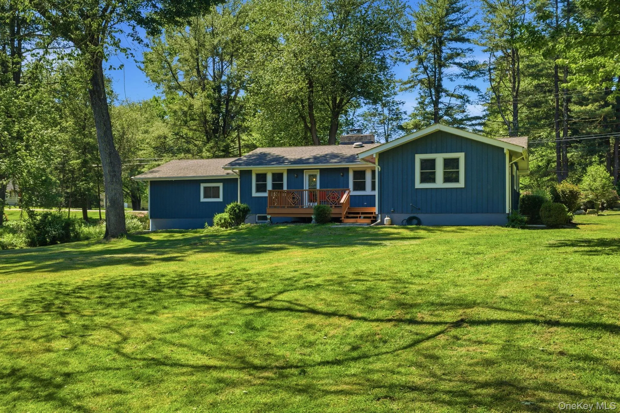 The freshly painted ranch shows off its clean single-level profile from the back. The freshly painted ranch shows off its clean single-level profile from the back.