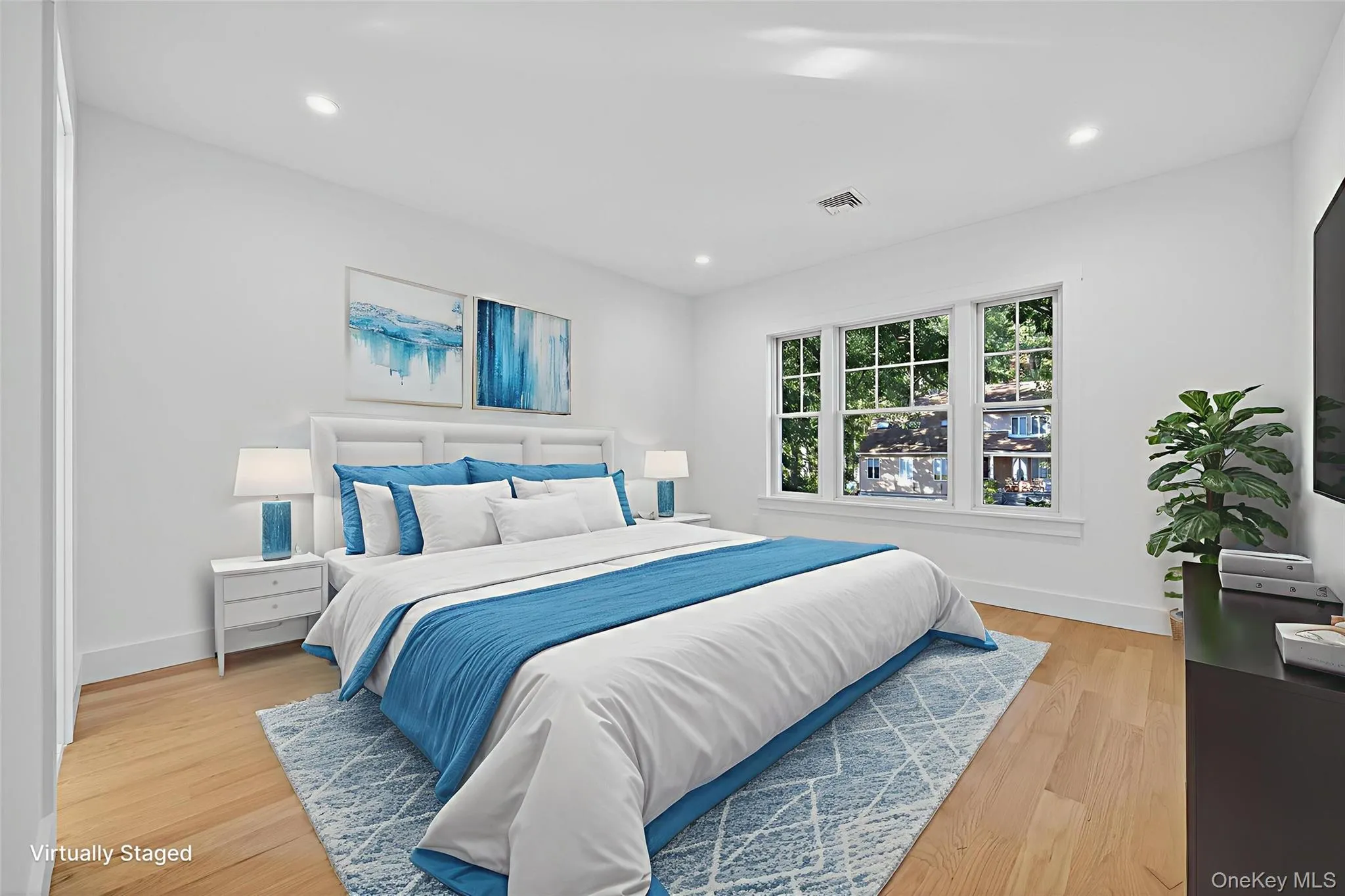 Bedroom with light wood-type flooring and recessed lighting Bedroom with light wood-type flooring and recessed lighting