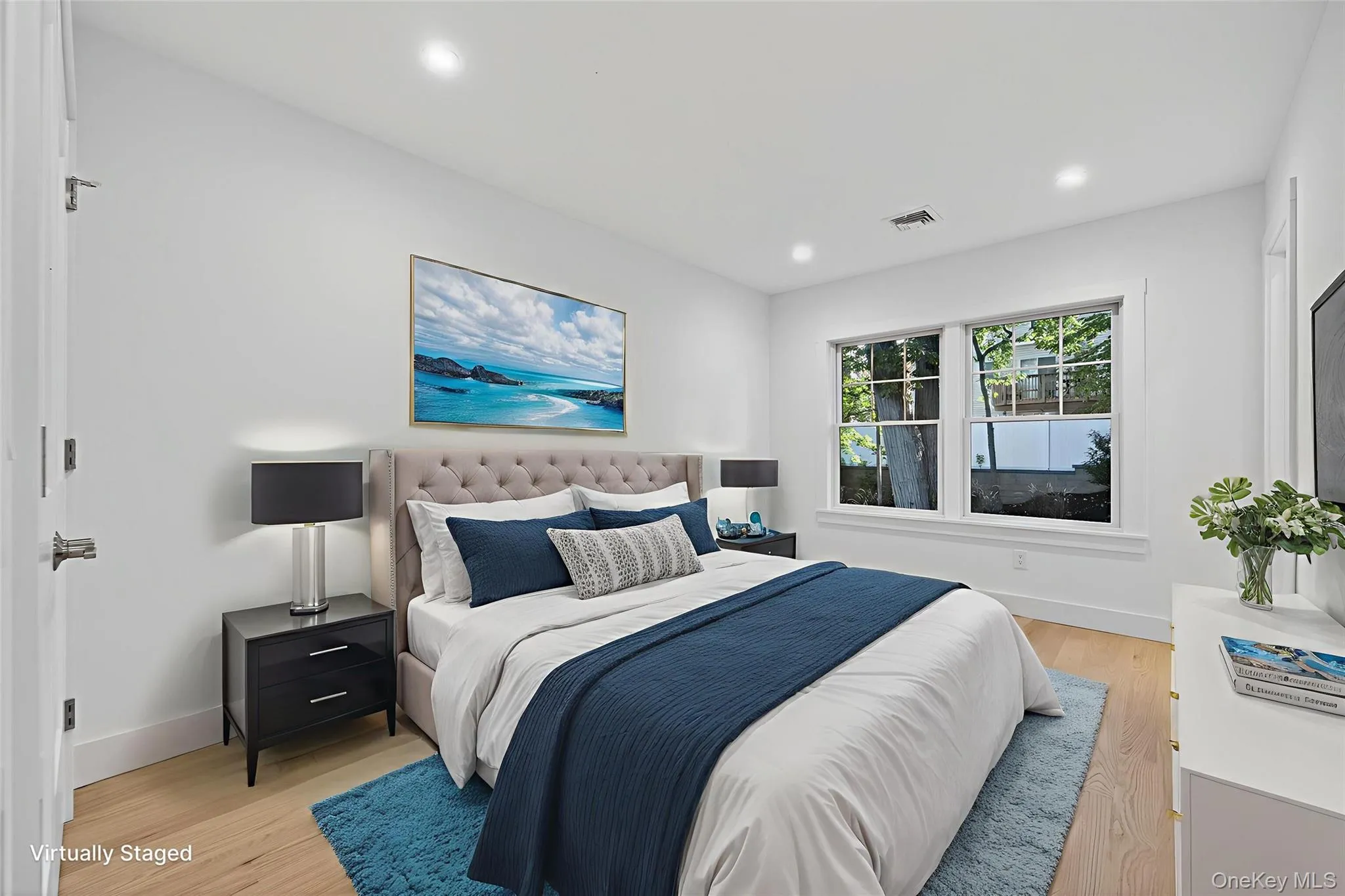 Bedroom featuring light wood finished floors and recessed lighting Bedroom featuring light wood finished floors and recessed lighting