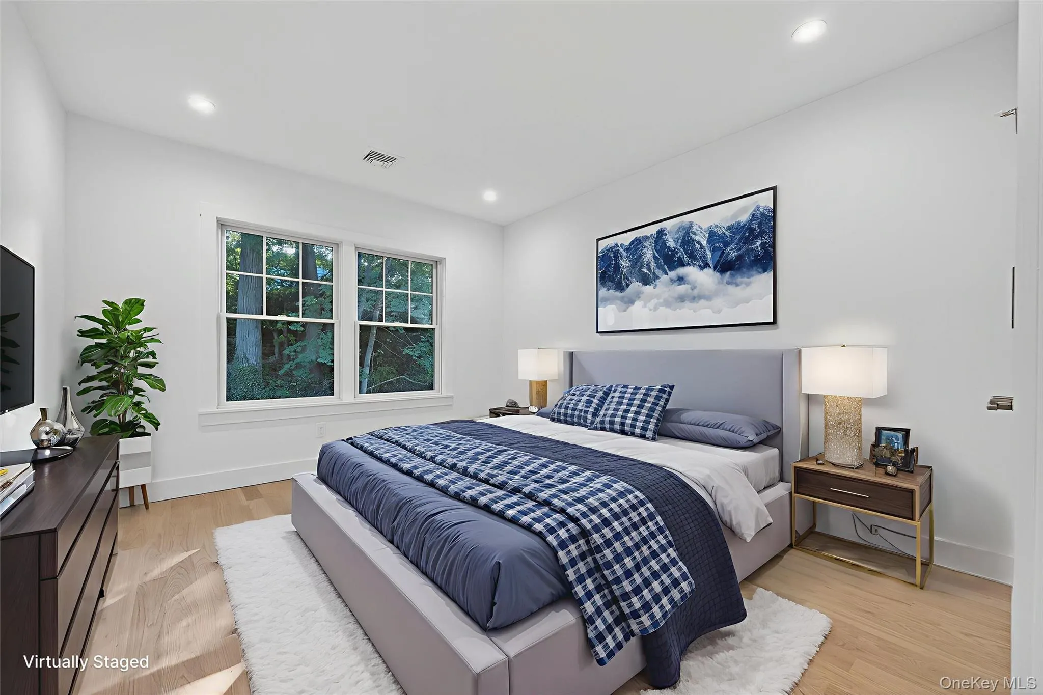 Bedroom with light wood-style floors and recessed lighting Bedroom with light wood-style floors and recessed lighting