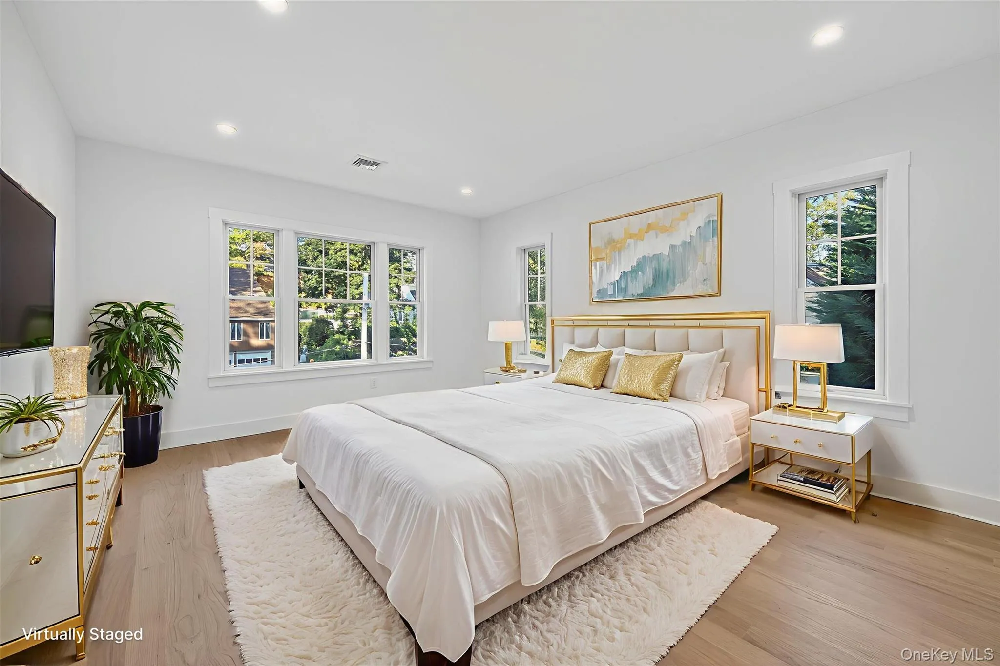 Bedroom featuring light wood finished floors and recessed lighting Bedroom featuring light wood finished floors and recessed lighting