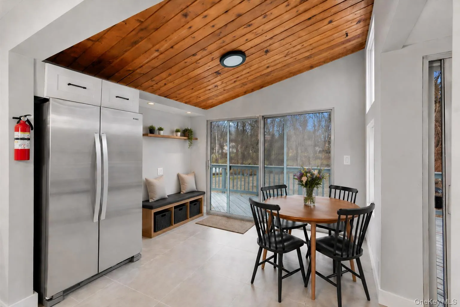 Staged breakfast area with sliding glass doors leading from kitchen to the deck and backyard. Staged breakfast area with sliding glass doors leading from kitchen to the deck and backyard.