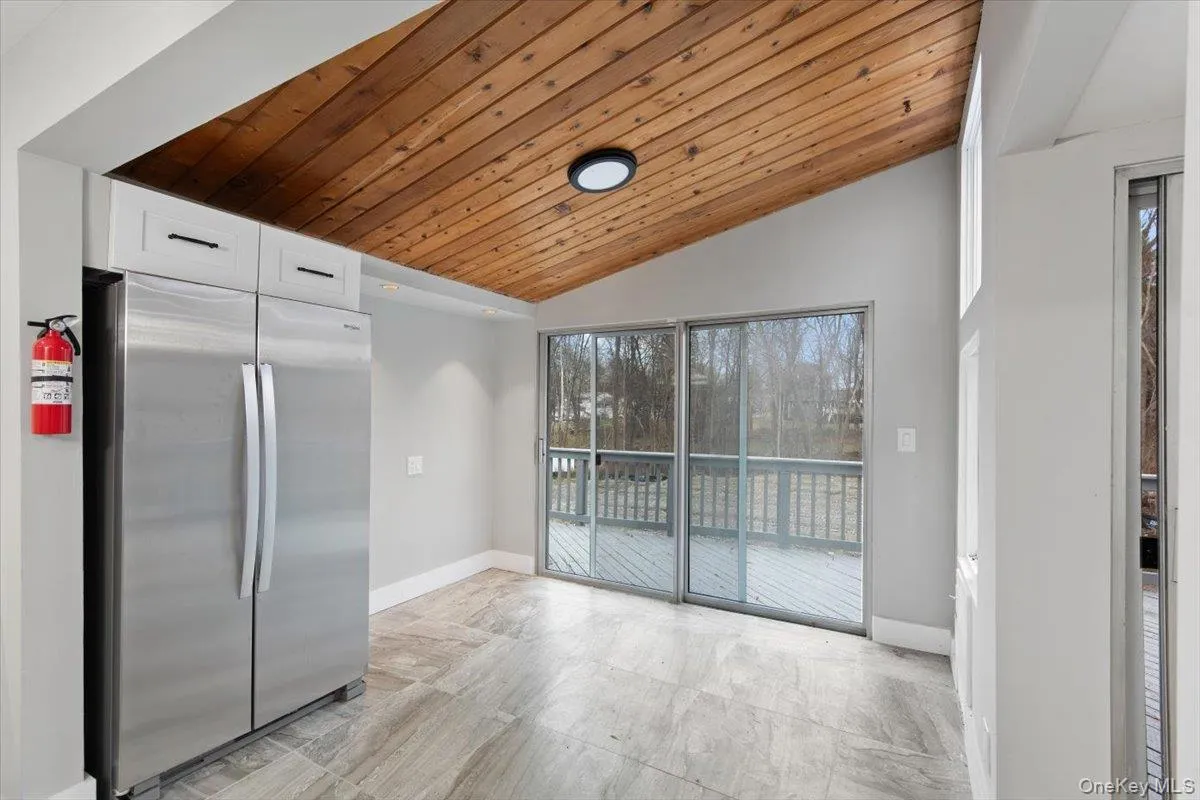Vaulted wood-plank ceiling above wood-finish flooring Vaulted wood-plank ceiling above wood-finish flooring