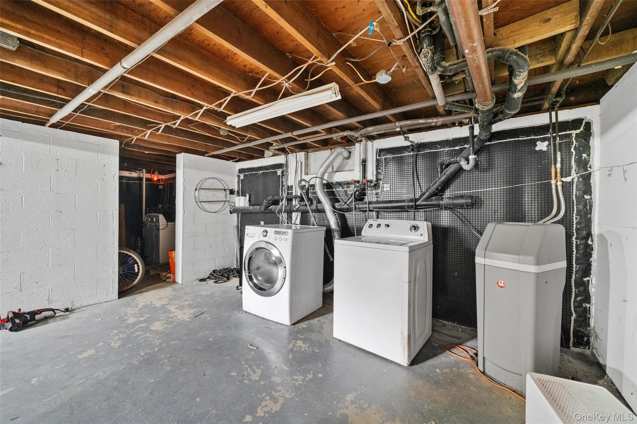 Unfinished basement featuring washing machine and clothes dryer Unfinished basement featuring washing machine and clothes dryer