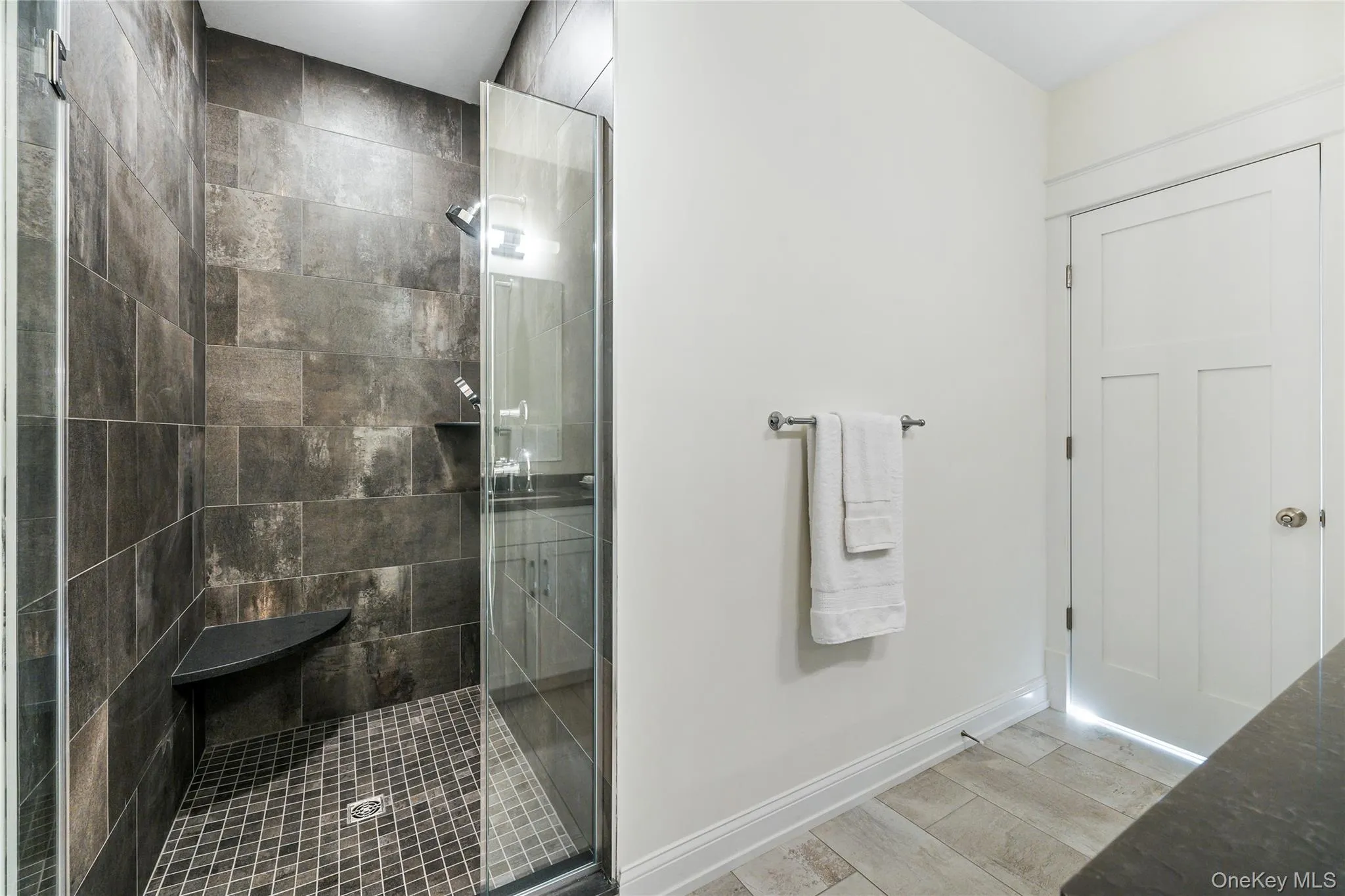 Bathroom featuring hardwood / wood-style flooring and a tile shower Bathroom featuring hardwood / wood-style flooring and a tile shower