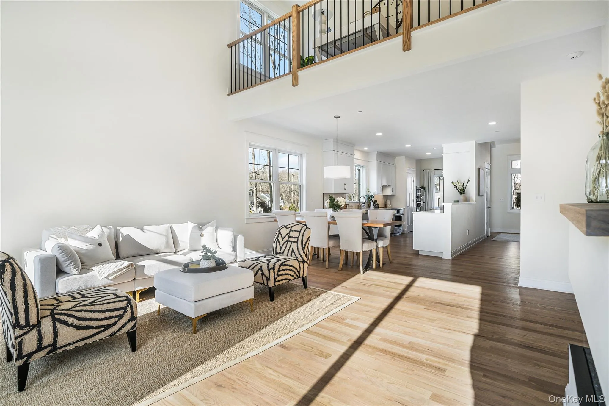 Living room featuring a towering ceiling and dark wood-type flooring Living room featuring a towering ceiling and dark wood-type flooring