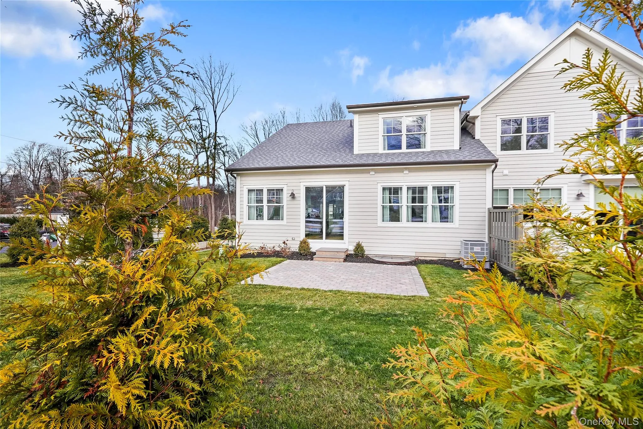 Back of house with a patio and a lawn Back of house with a patio and a lawn