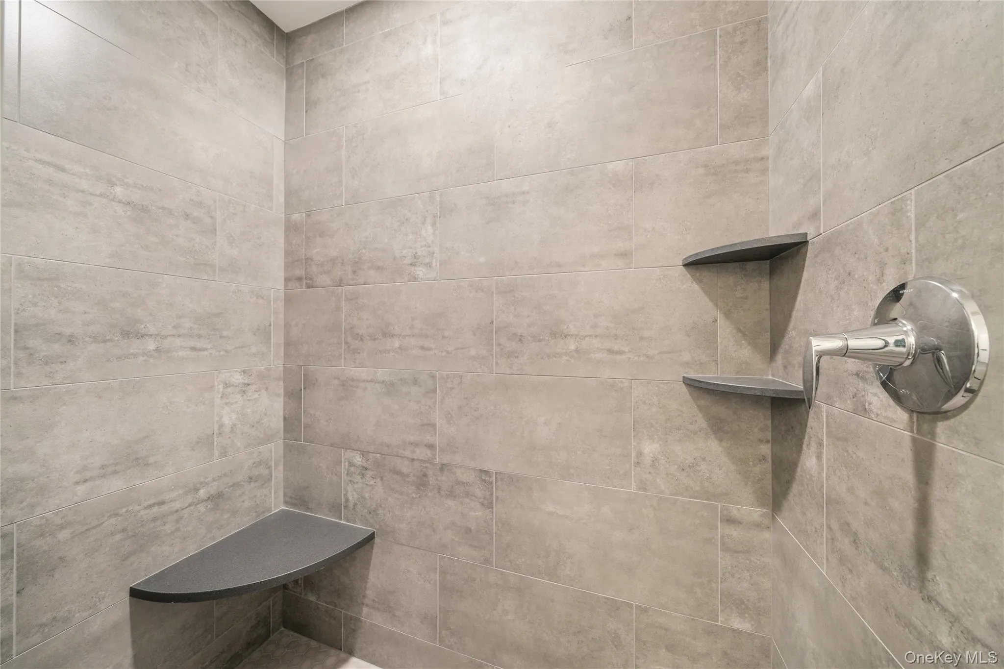 Bathroom featuring tiled shower Bathroom featuring tiled shower