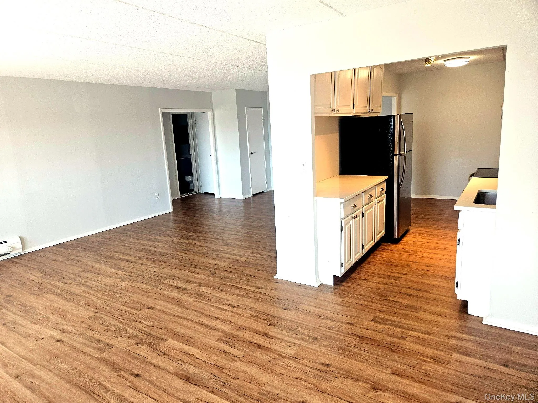 View from dining room into living room and kitchen. View from dining room into living room and kitchen.