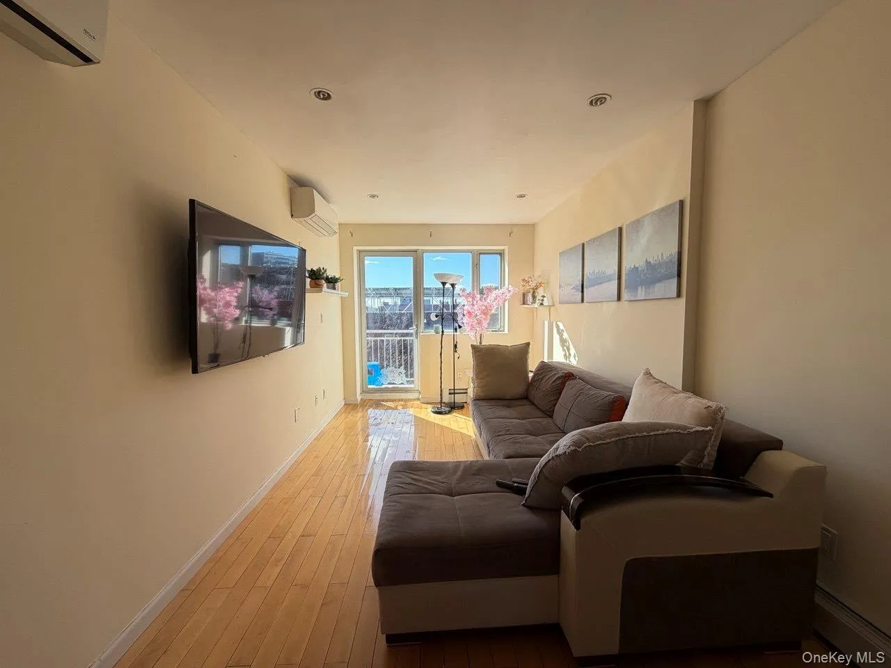Hardwood flooring extending throughout, recessed ceiling lighting, and a rear door with balcony access Hardwood flooring extending throughout, recessed ceiling lighting, and a rear door with balcony access