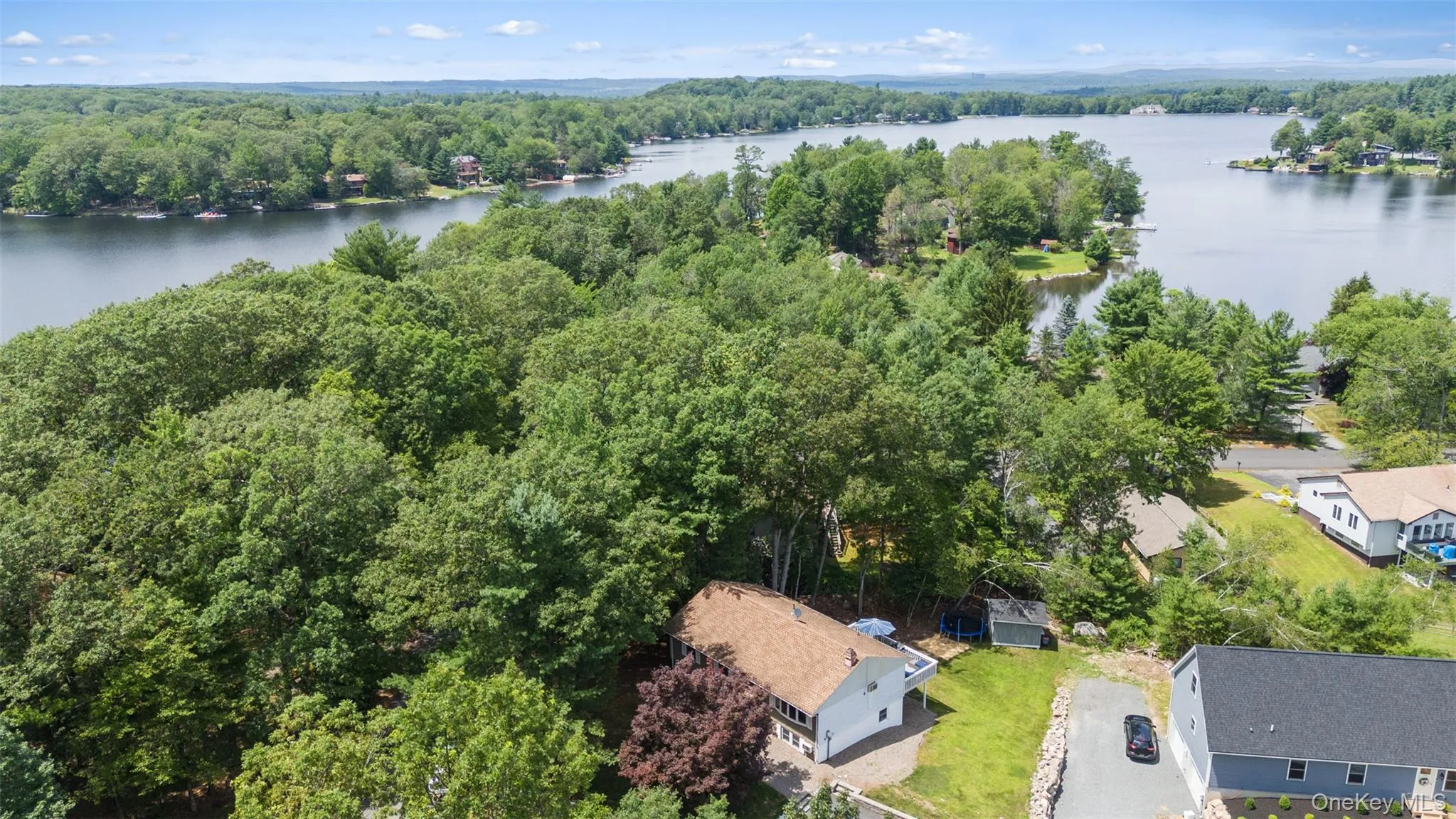 Drone / aerial view of a large body of water and a heavily wooded area Drone / aerial view of a large body of water and a heavily wooded area