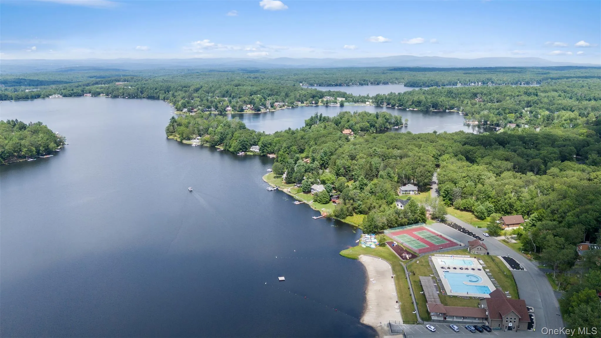 Bird's eye view of a heavily wooded area and a large body of water Bird's eye view of a heavily wooded area and a large body of water