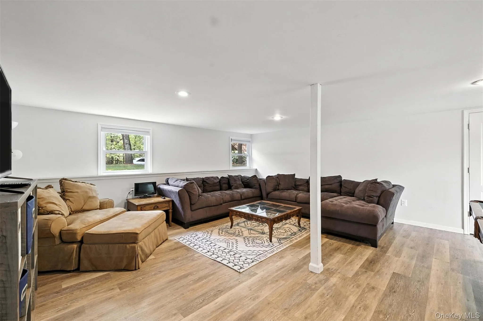 Living area with light wood-style floors and recessed lighting Living area with light wood-style floors and recessed lighting