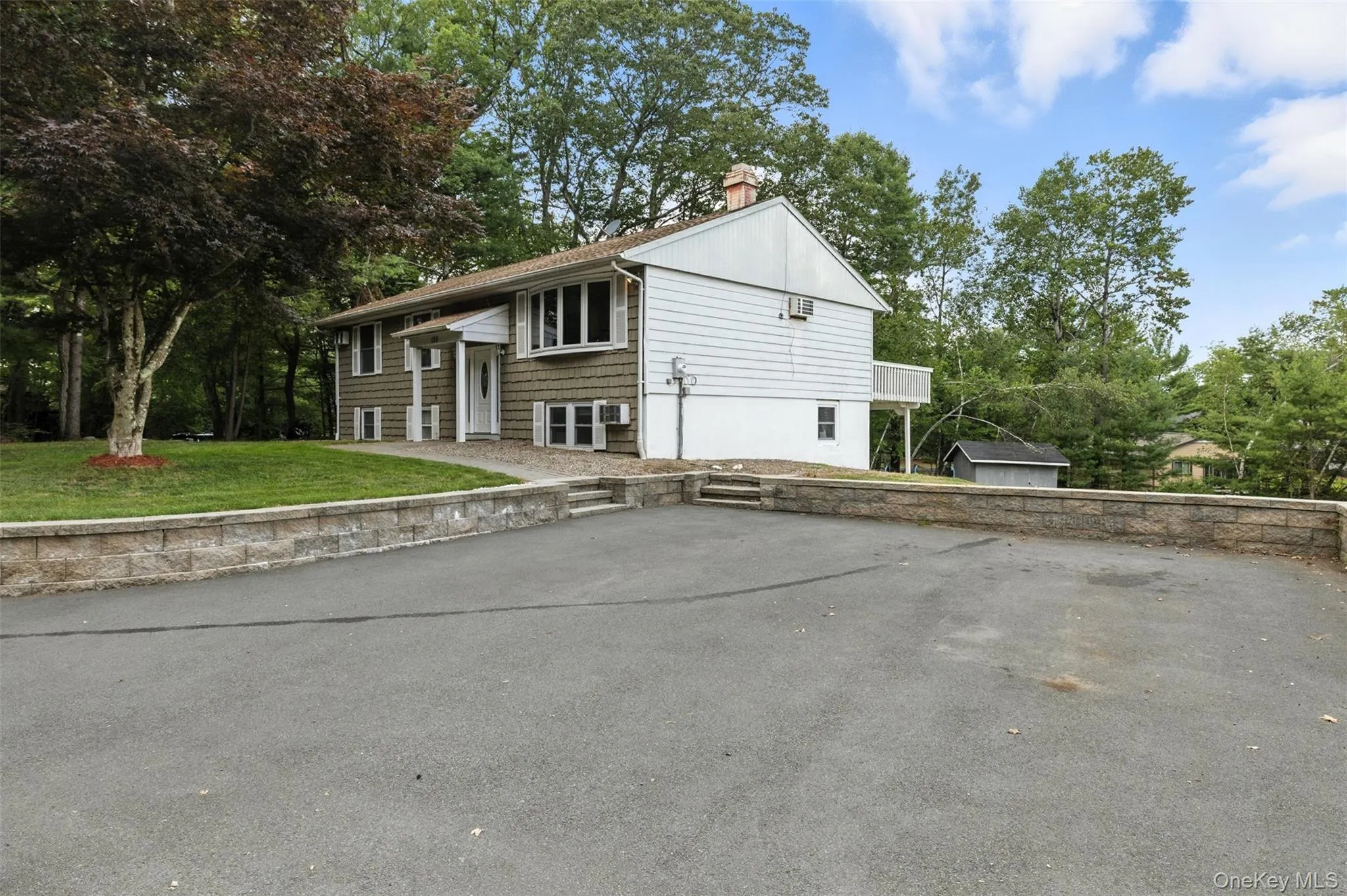 Raised ranch with a front yard and a chimney Raised ranch with a front yard and a chimney