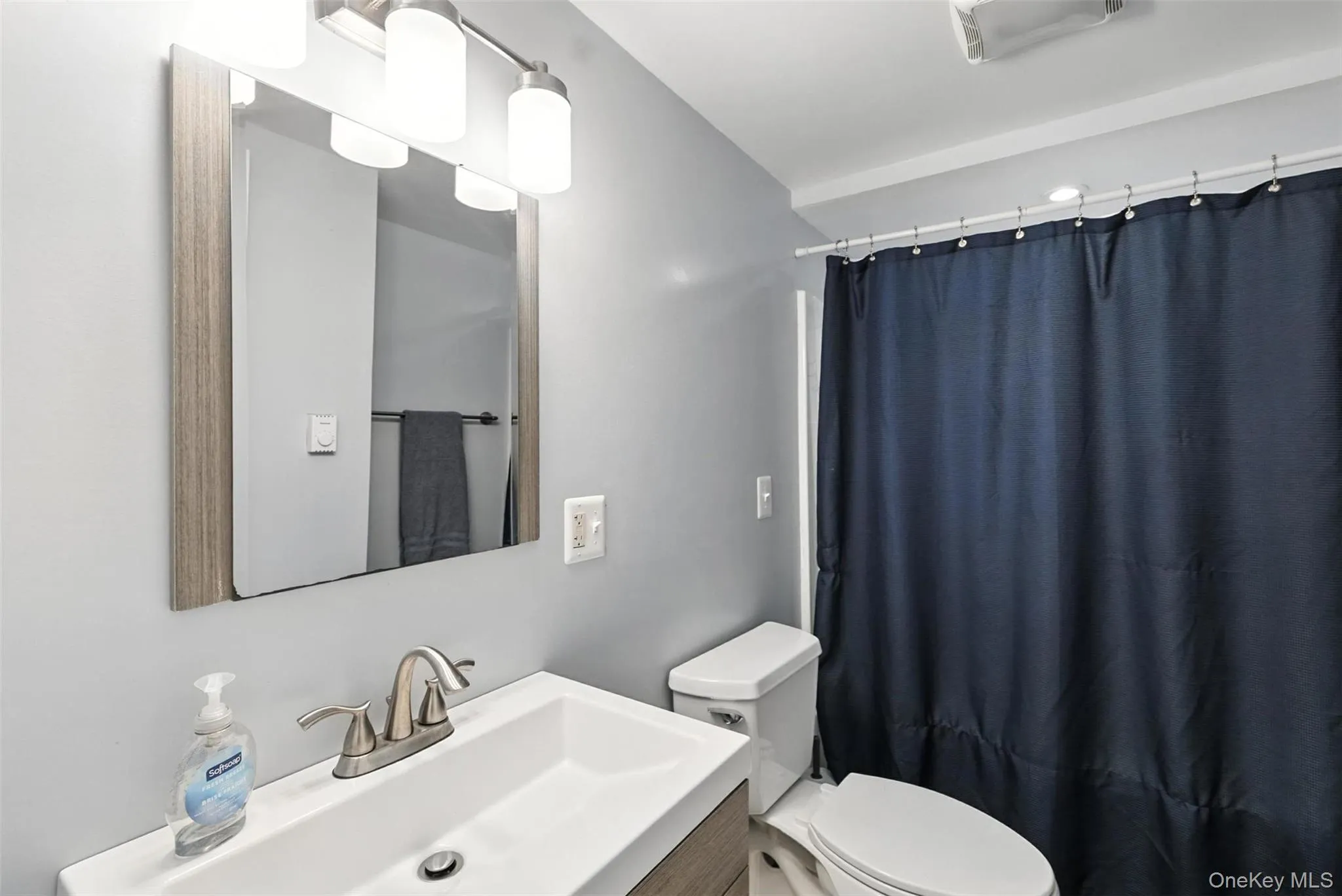 Full bath featuring vanity and curtained shower Full bath featuring vanity and curtained shower