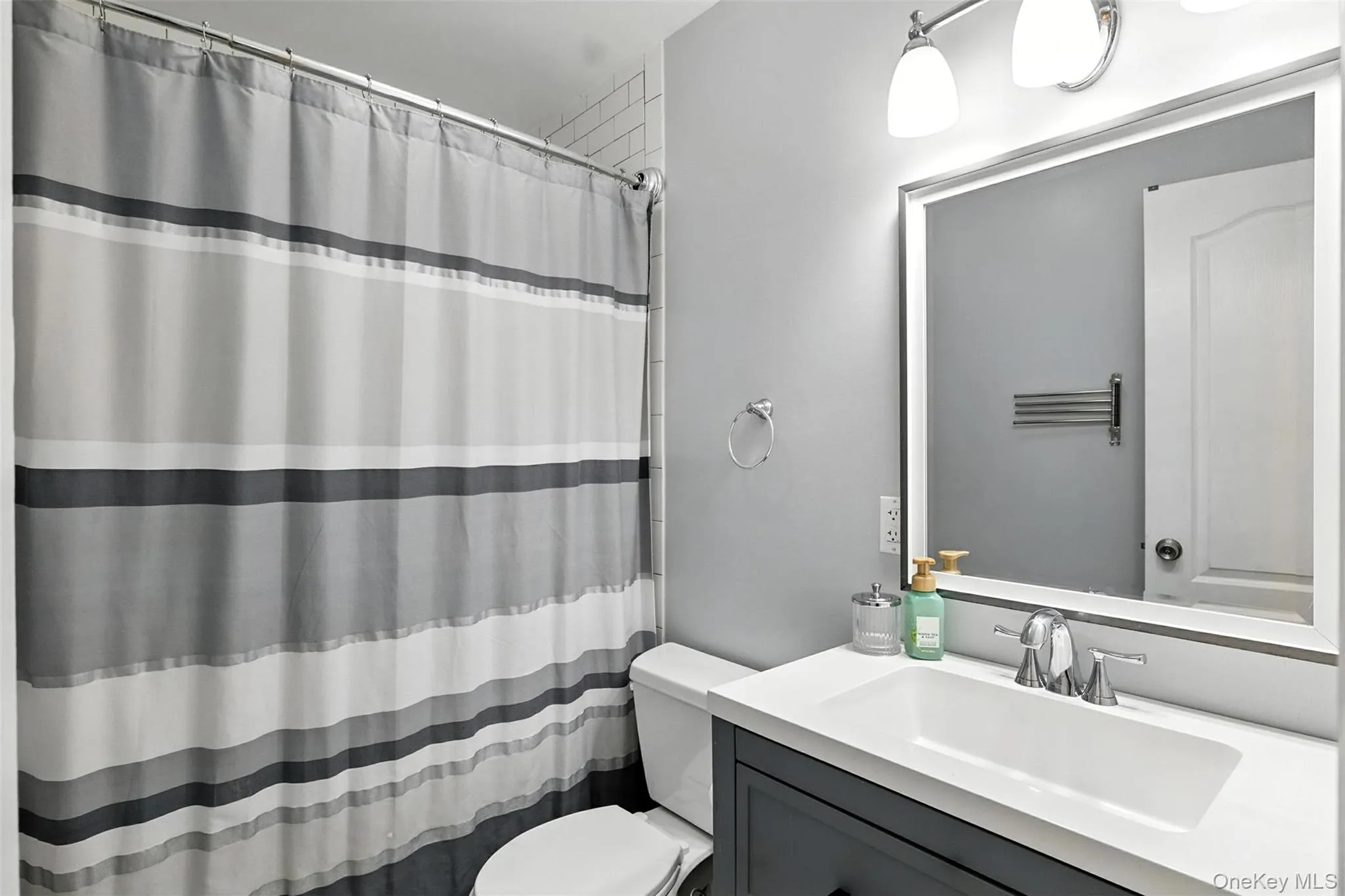 Full bathroom featuring vanity and curtained shower Full bathroom featuring vanity and curtained shower