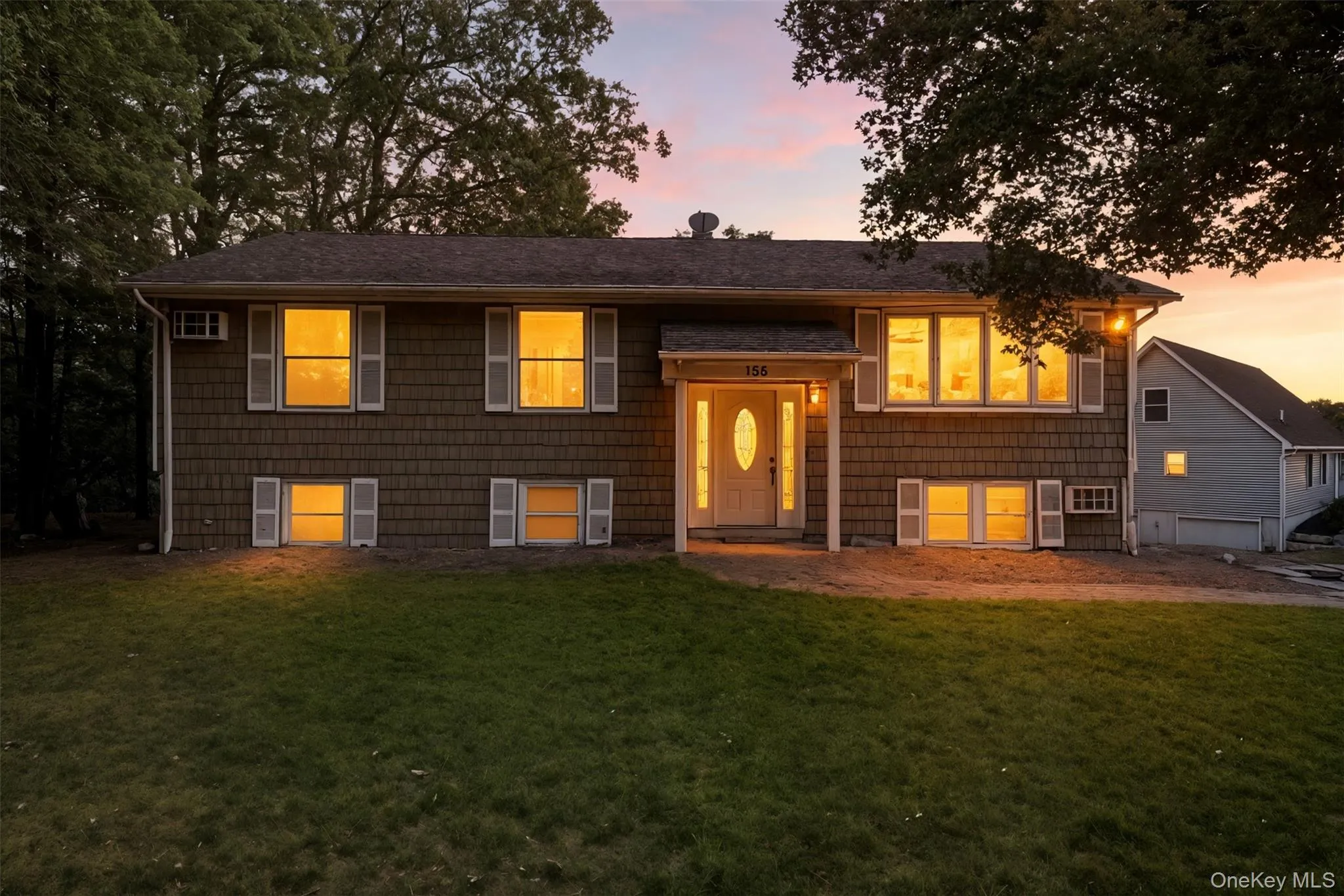 Bi-level home featuring a front yard Bi-level home featuring a front yard