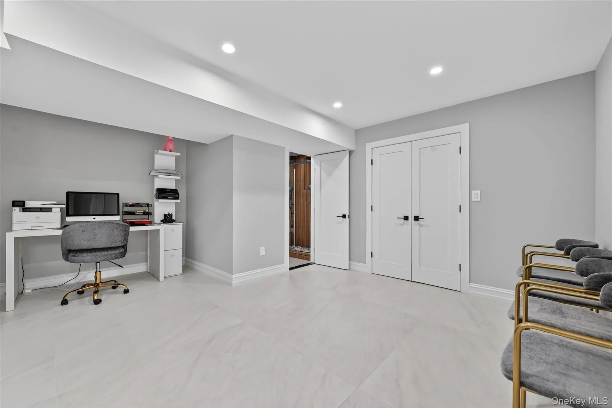 Spacious room featuring light gray walls, large format tile flooring, recessed lighting, and white trim Spacious room featuring light gray walls, large format tile flooring, recessed lighting, and white trim
