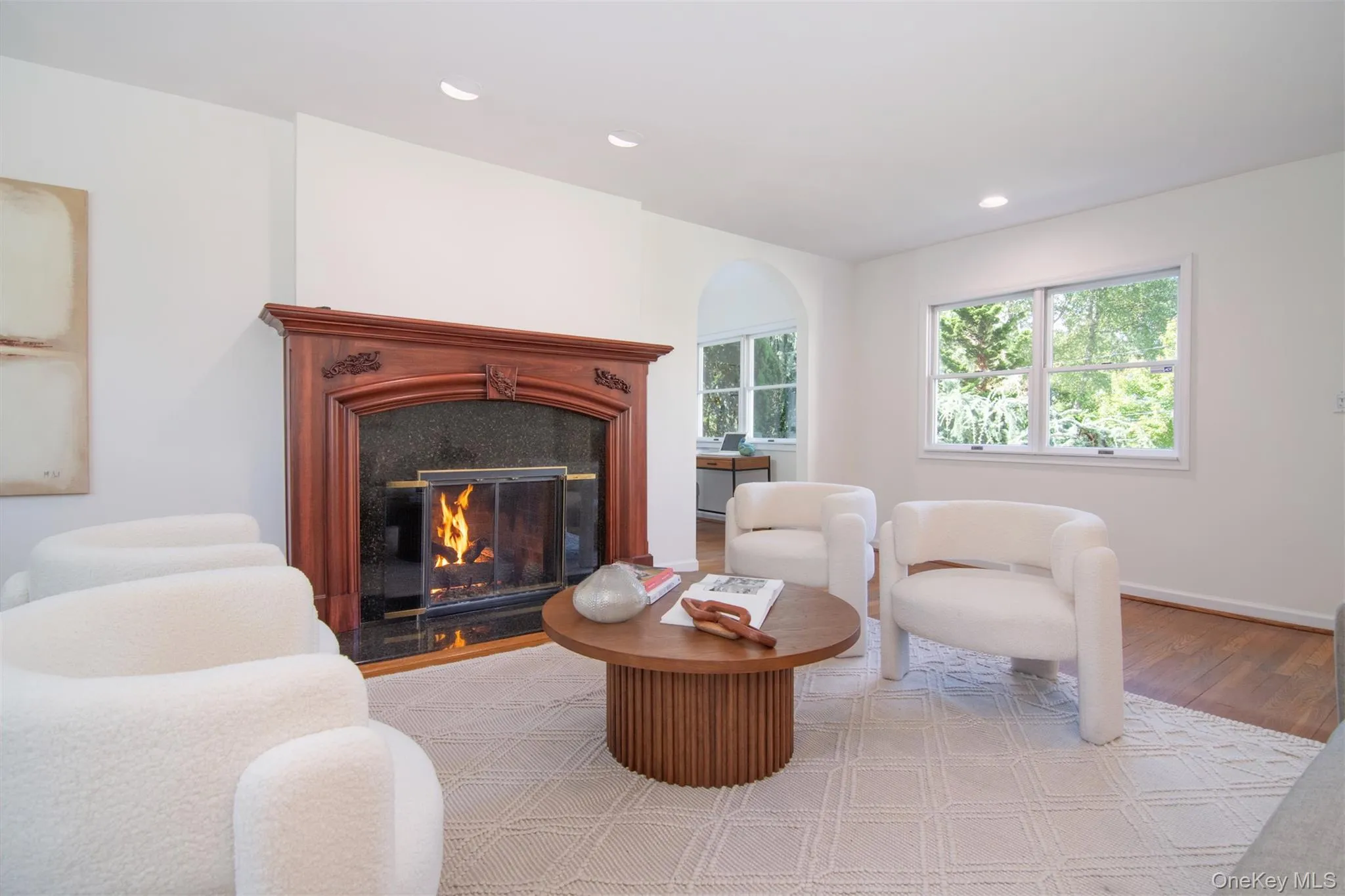 Sitting room featuring a premium fireplace, wood finished floors, and recessed lighting Sitting room featuring a premium fireplace, wood finished floors, and recessed lighting
