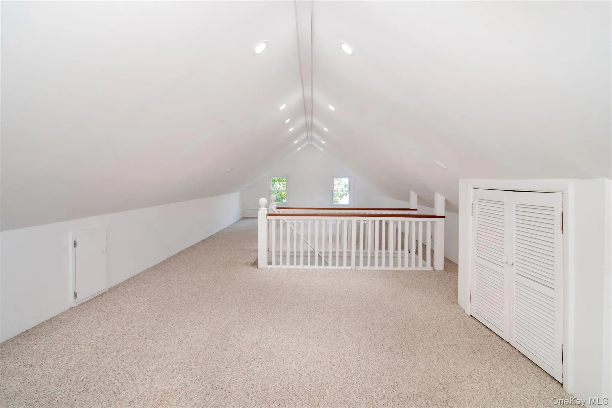 Additional living space featuring carpet and vaulted ceiling Additional living space featuring carpet and vaulted ceiling