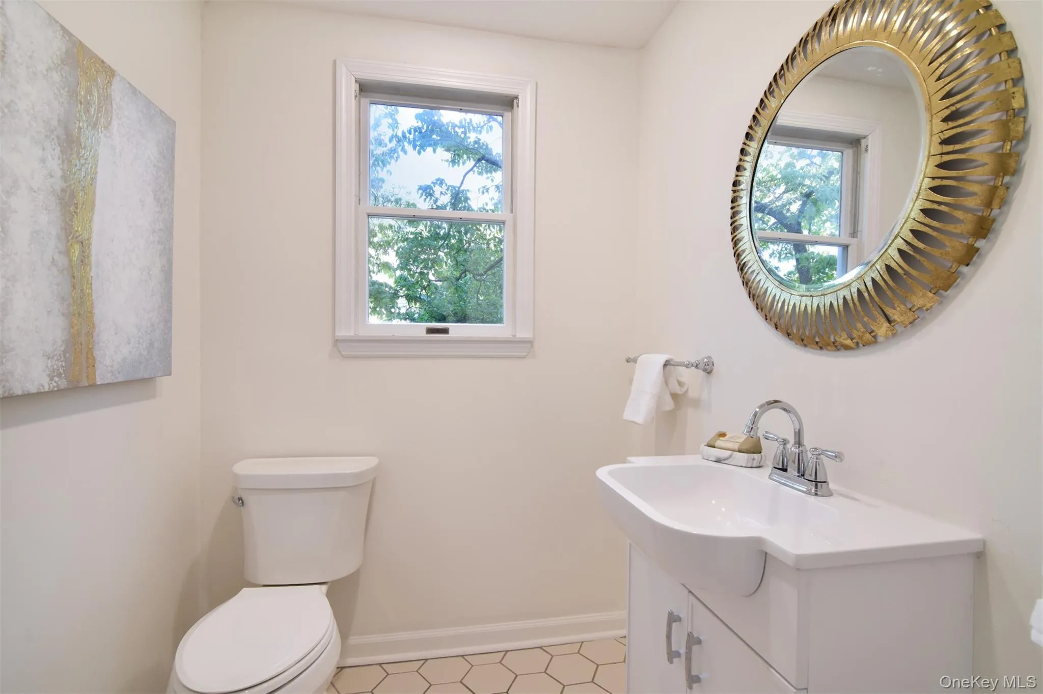 Half bath featuring healthy amount of natural light and vanity Half bath featuring healthy amount of natural light and vanity