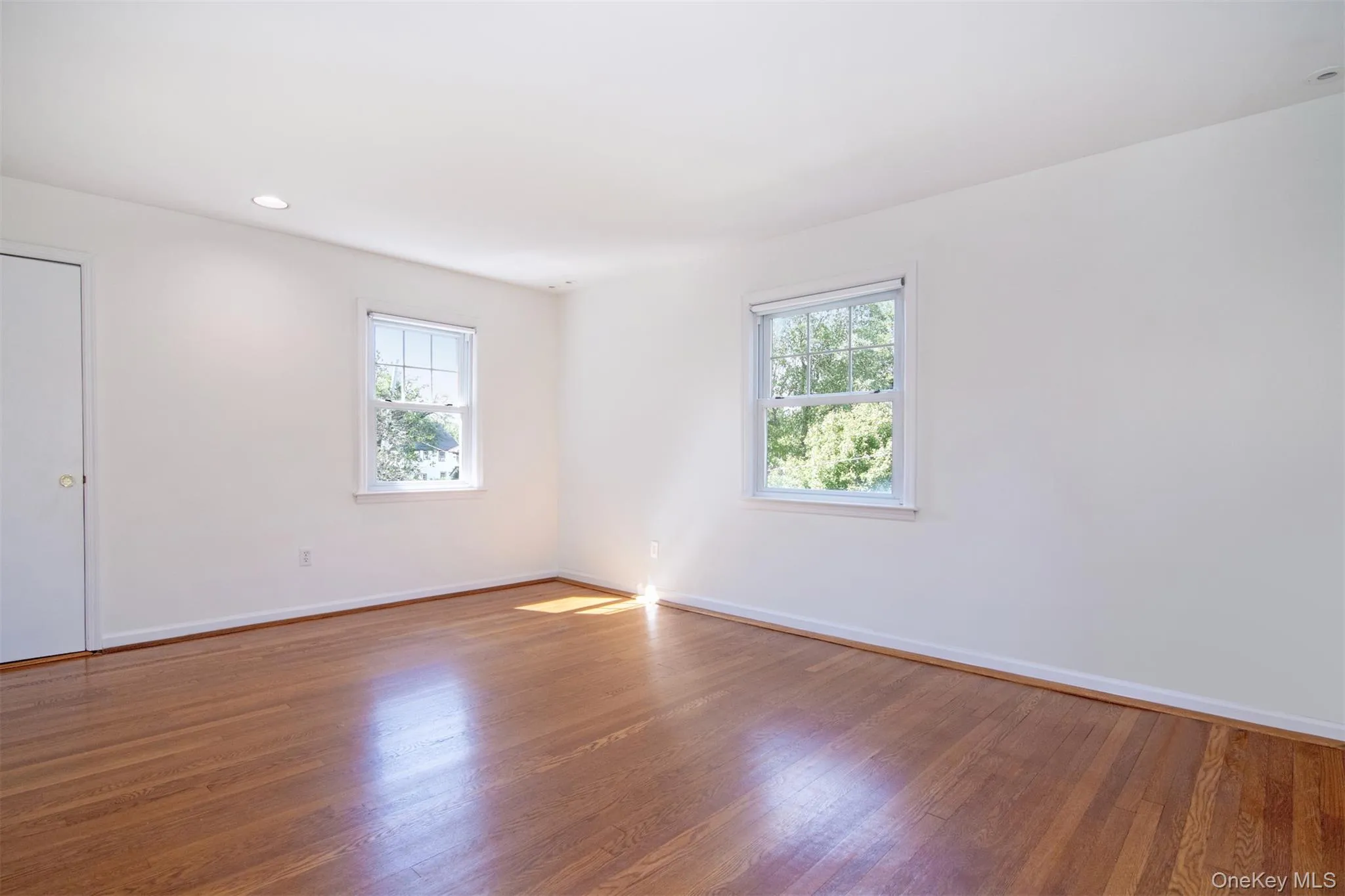 Unfurnished room featuring wood-type flooring and recessed lighting Unfurnished room featuring wood-type flooring and recessed lighting