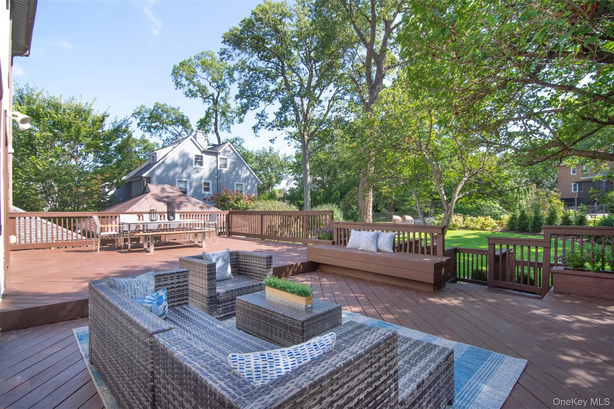 Wooden deck featuring an outdoor living space and view of wooded area Wooden deck featuring an outdoor living space and view of wooded area