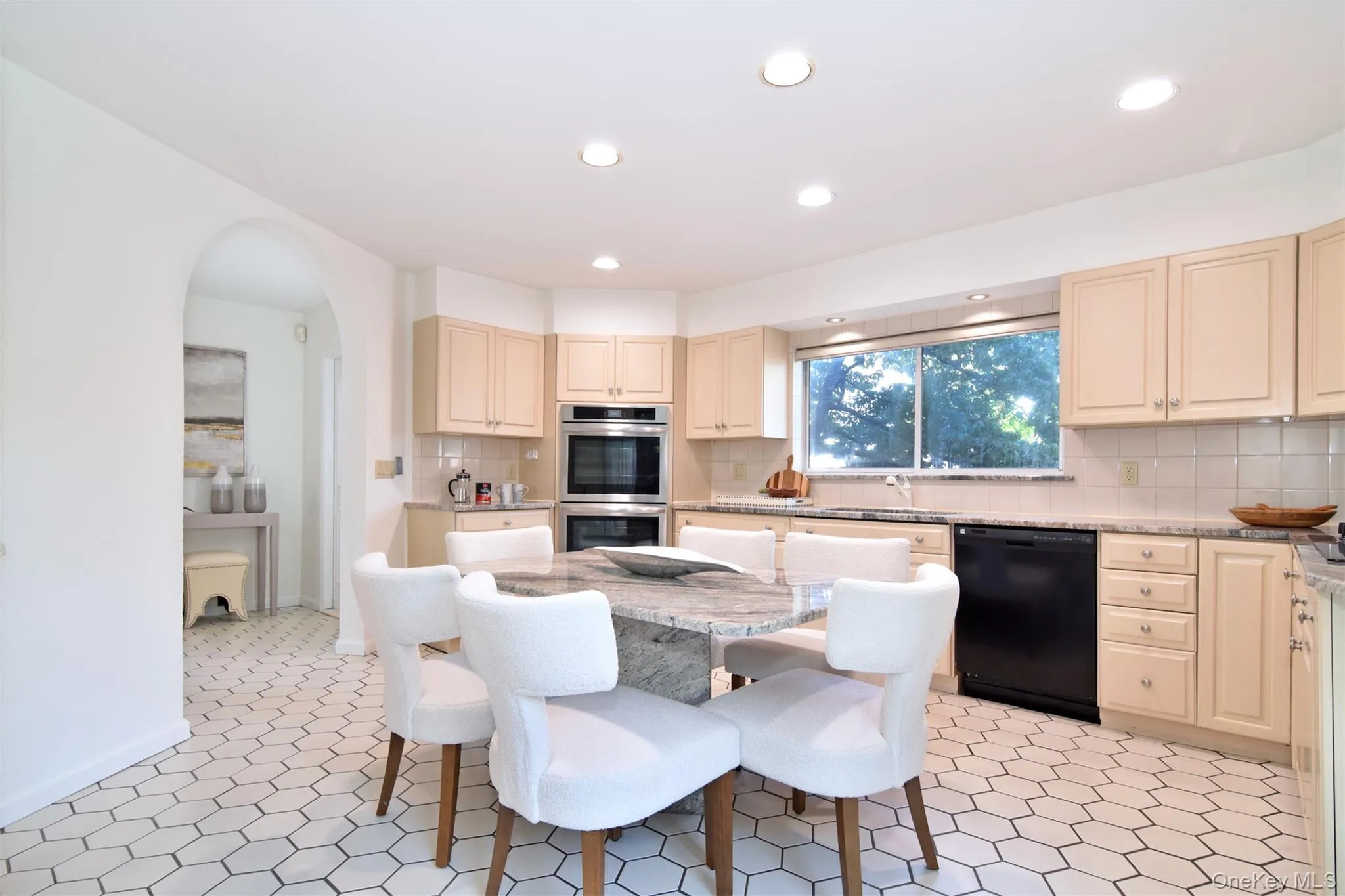 Kitchen with light stone countertops, dishwasher, tasteful backsplash, stainless steel double oven, and recessed lighting Kitchen with light stone countertops, dishwasher, tasteful backsplash, stainless steel double oven, and recessed lighting