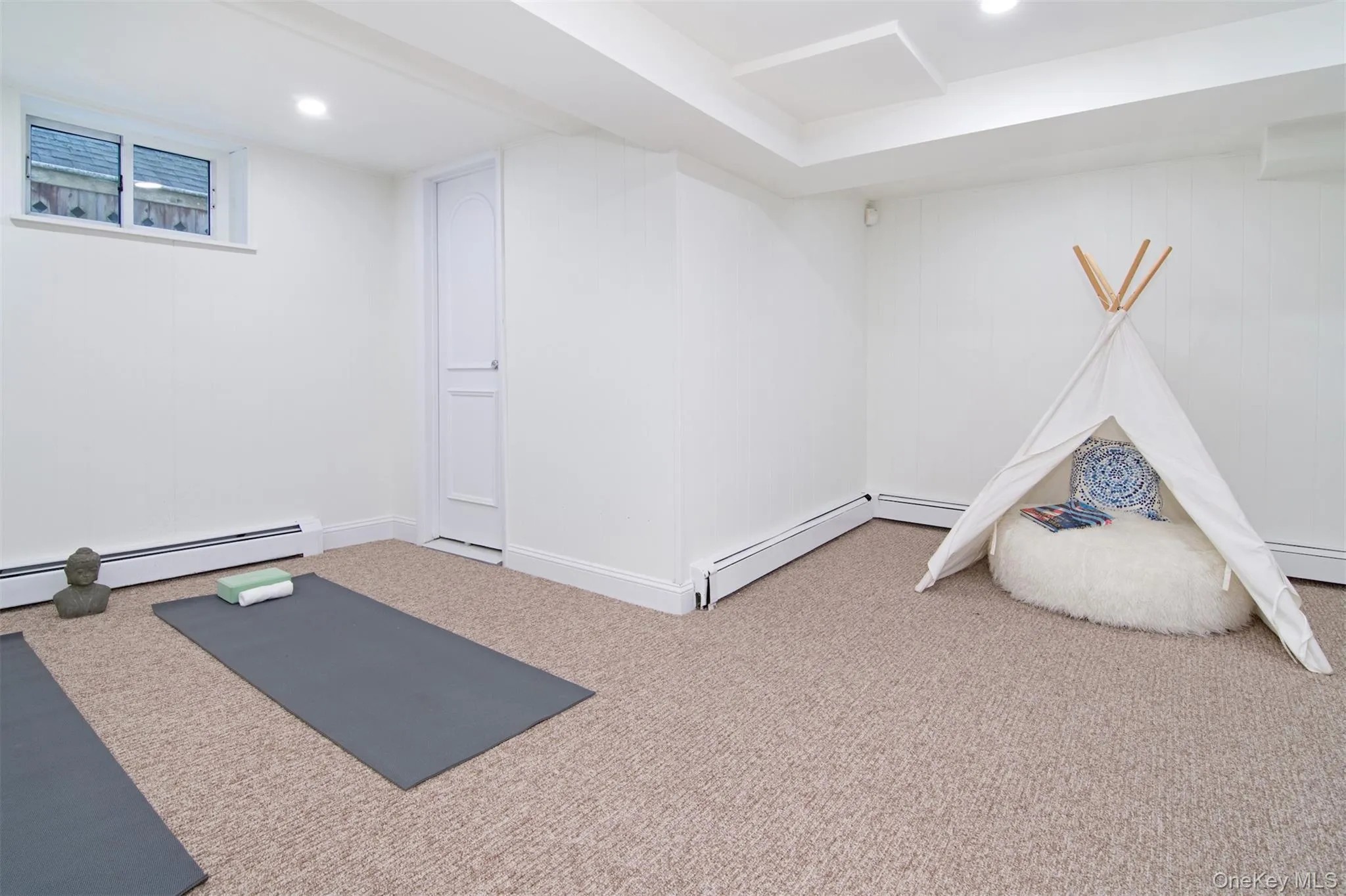 Workout room featuring carpet flooring, a baseboard radiator, and recessed lighting Workout room featuring carpet flooring, a baseboard radiator, and recessed lighting
