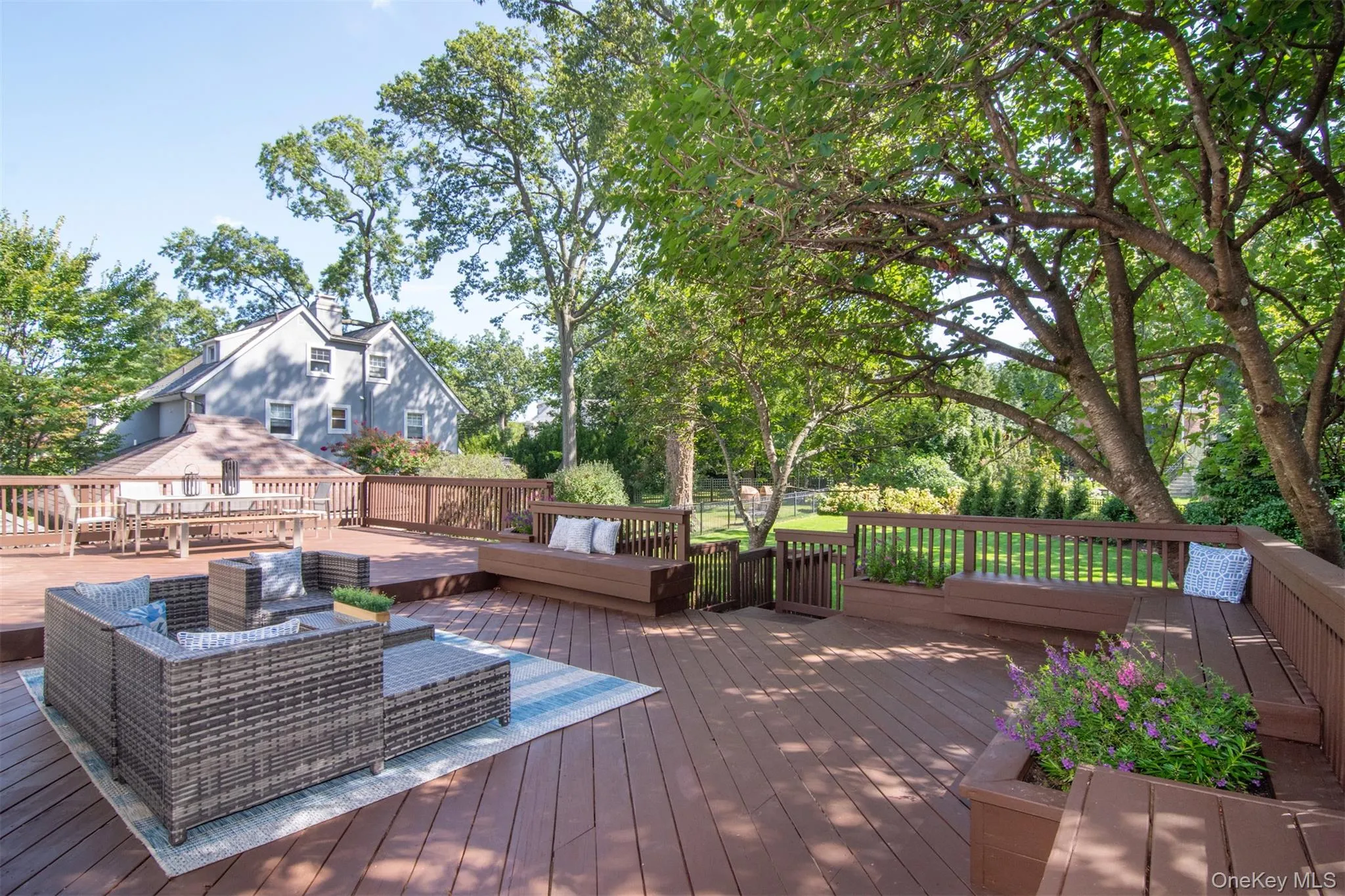 Wooden terrace with view of wooded area and an outdoor hangout area Wooden terrace with view of wooded area and an outdoor hangout area