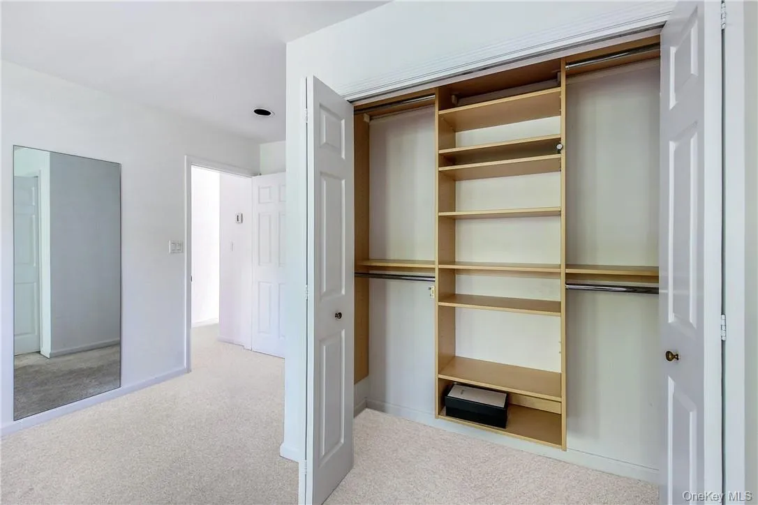 Primary bedroom closet with organizer Primary bedroom closet with organizer