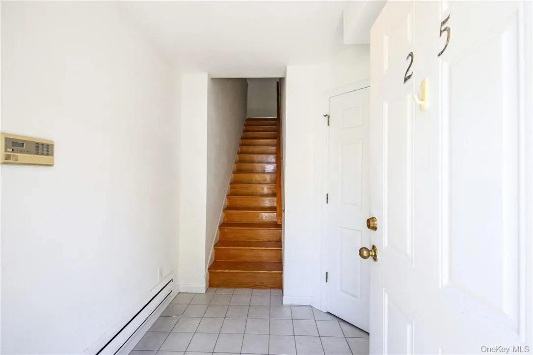 Entry foyer and stairs to second floor Entry foyer and stairs to second floor