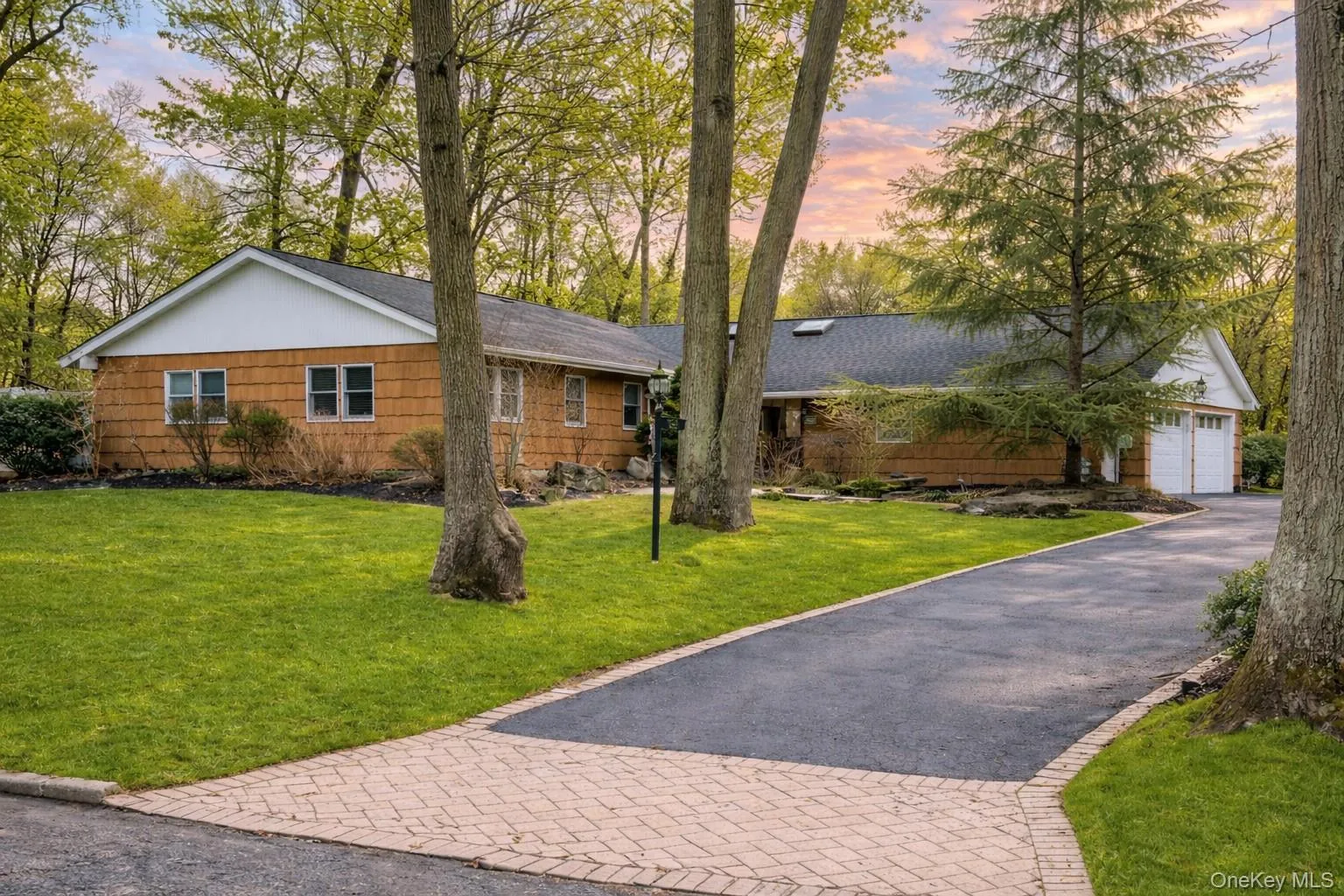 Single story home with a yard, a garage, and asphalt driveway Single story home with a yard, a garage, and asphalt driveway
