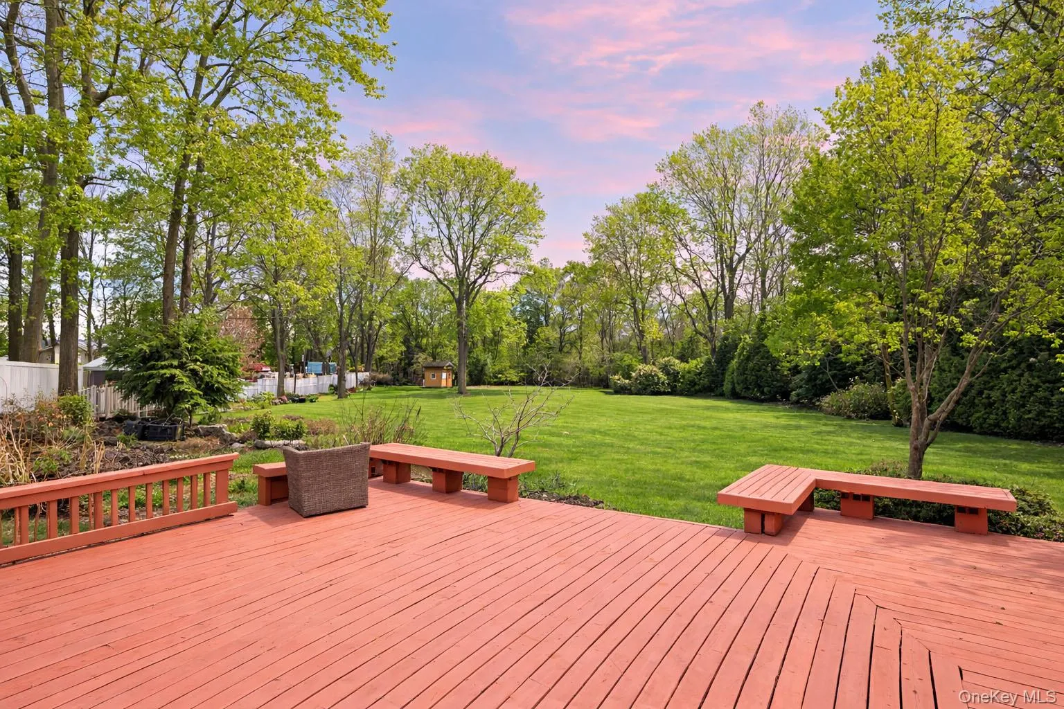 Wooden deck with a yard and view of scattered trees Wooden deck with a yard and view of scattered trees