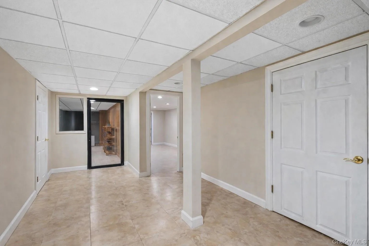 Finished basement with a paneled ceiling and recessed lighting Finished basement with a paneled ceiling and recessed lighting