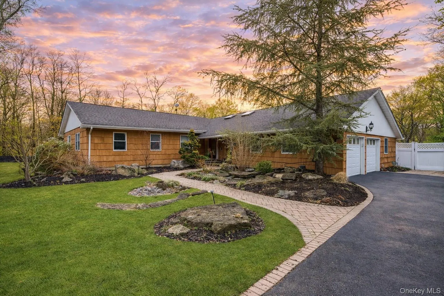 Ranch-style house with driveway and an attached garage Ranch-style house with driveway and an attached garage