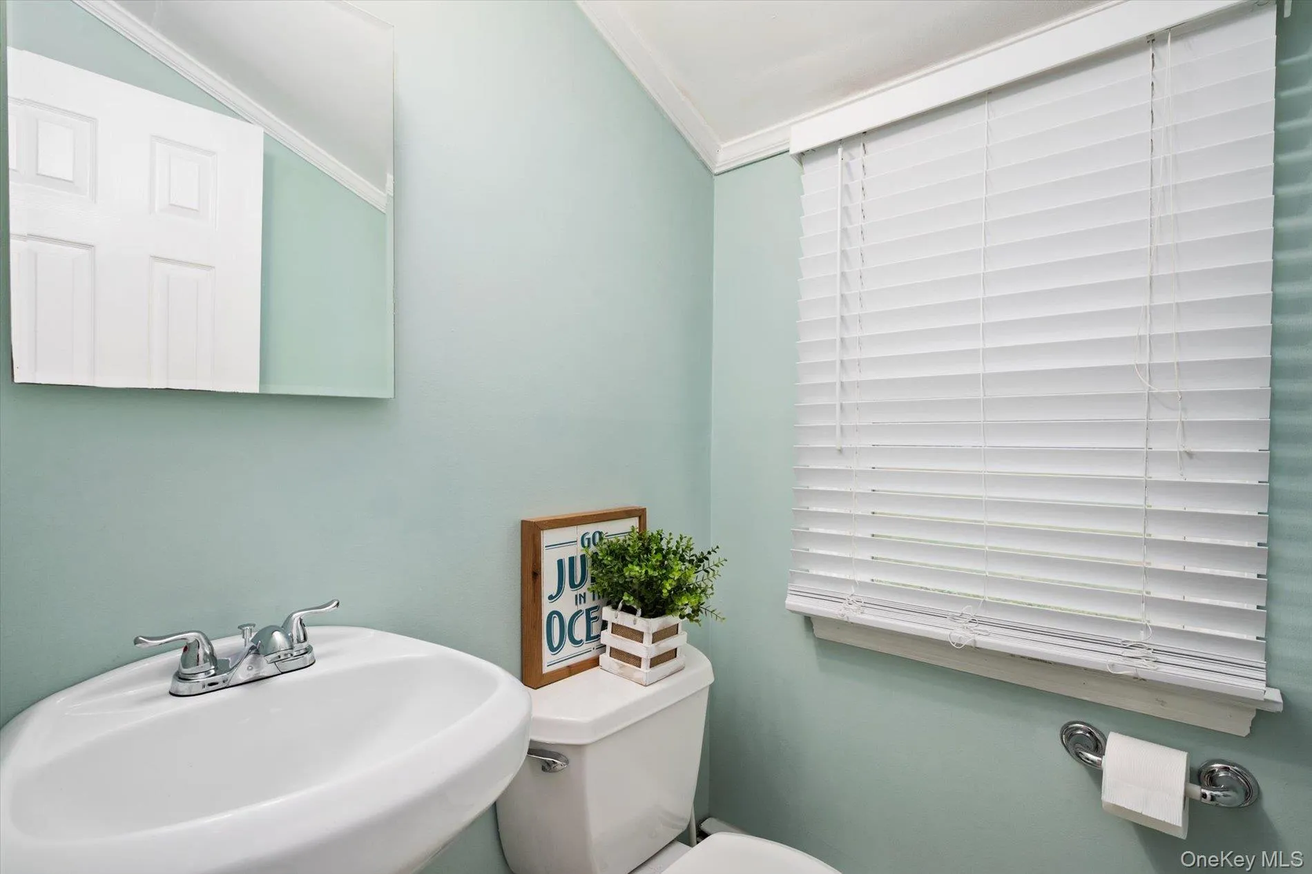 Half bathroom with toilet and ornamental molding Half bathroom with toilet and ornamental molding