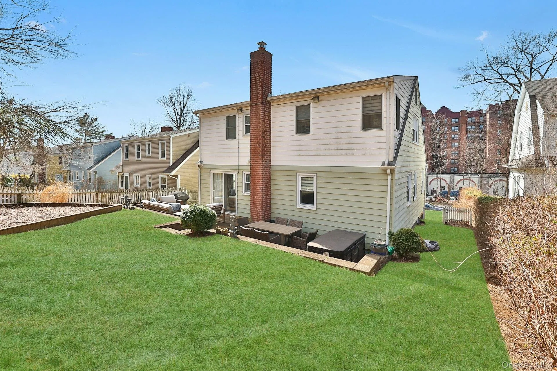 Back of property featuring an outdoor living space, a lawn, and a patio area Back of property featuring an outdoor living space, a lawn, and a patio area