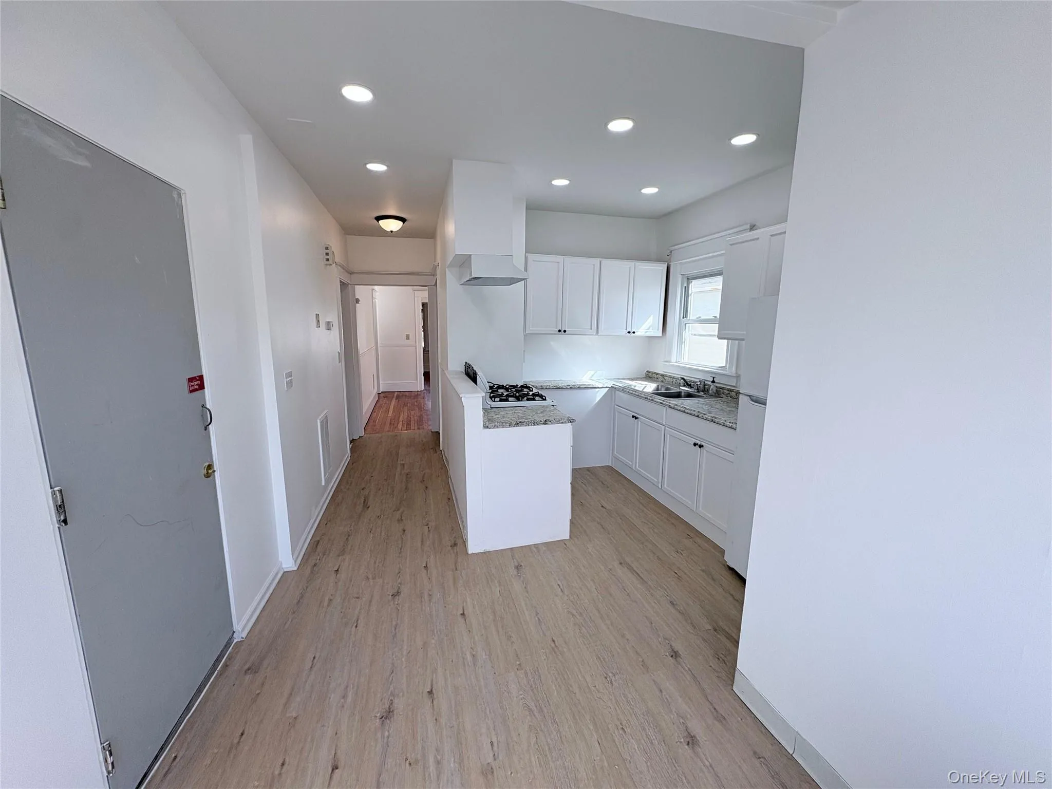 Kitchen with white cabinetry, light-toned countertops. Kitchen with white cabinetry, light-toned countertops.