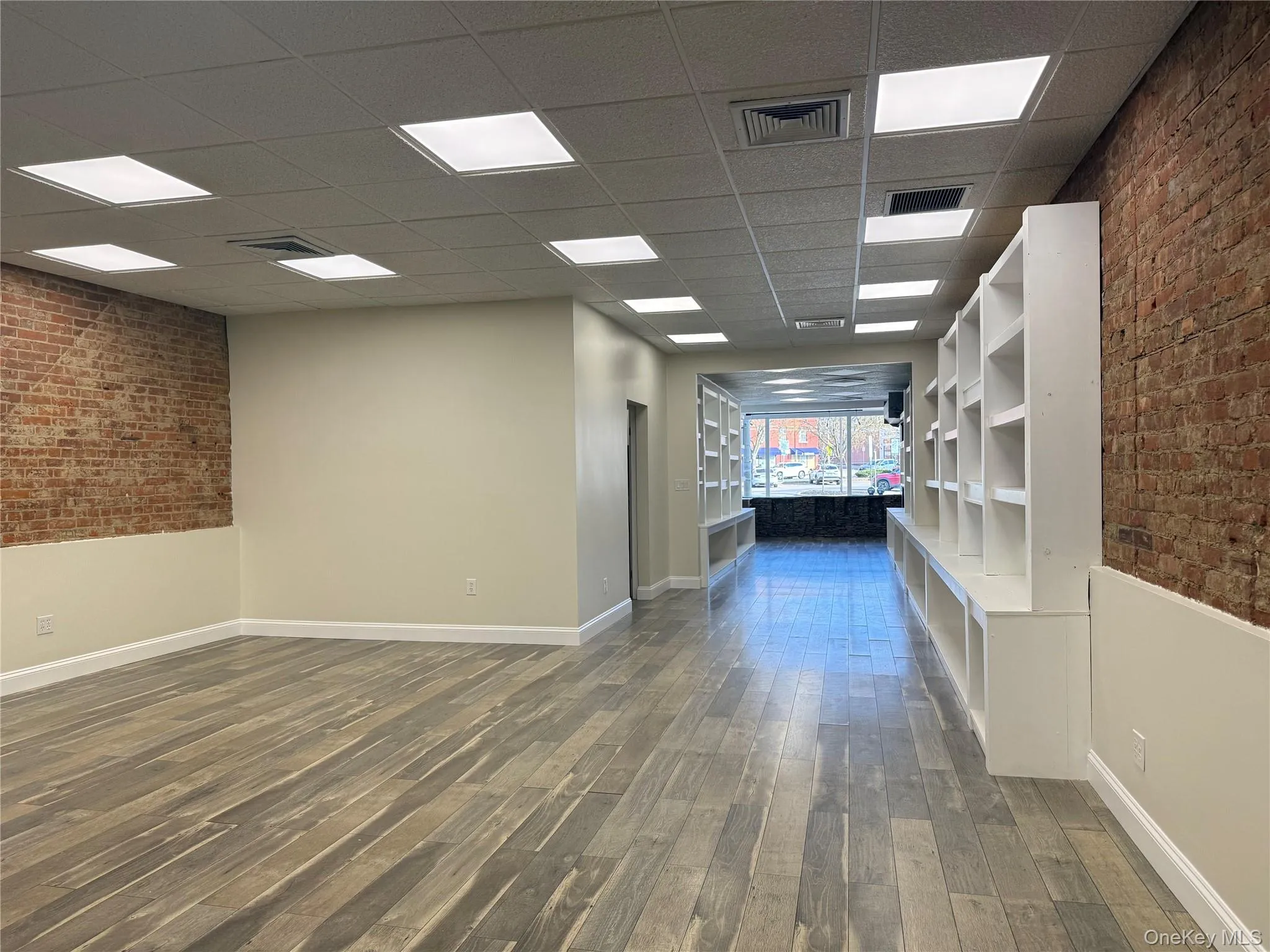 Looking from the back of the space towards the front - Opens up to a larger area- lots of lighting! Looking from the back of the space towards the front - Opens up to a larger area- lots of lighting!