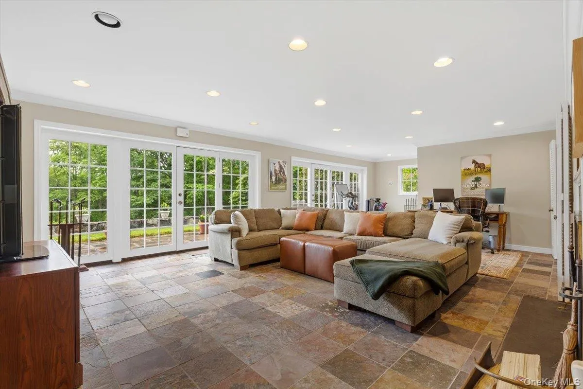 Huge walk-out lower level Recreation Room with wall of French doors/windows, tiled floors and recessed lights. Huge walk-out lower level Recreation Room with wall of French doors/windows, tiled floors and recessed lights.